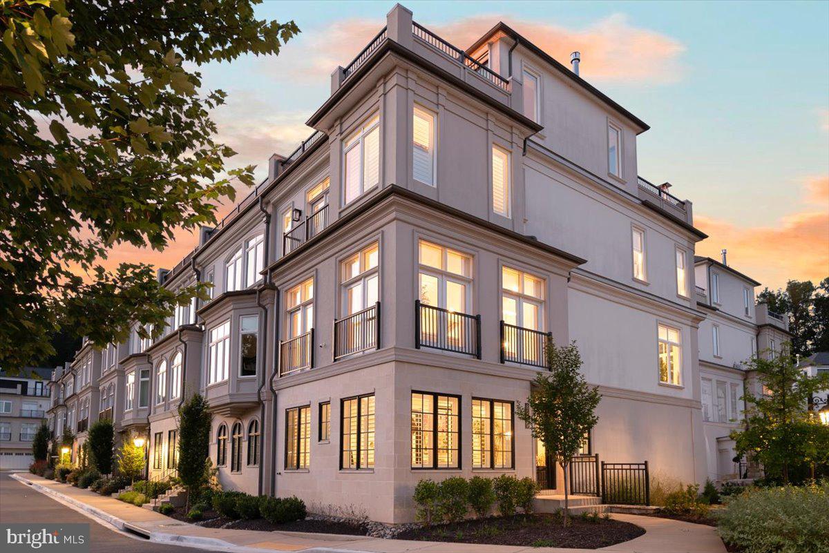 Welcome home to this exquisite end-unit rowhome in coveted Quarry Springs!  Thoughtfully and graciously upgraded, this sun-soaked beauty showcases top-of-the-line improvements that include Restoration Hardware light fixtures, custom window panels and drapes, additional built-ins, plantation shutters, sliding glass panels that open the upper level family room to two roof terraces.  Enjoy electric screens and electric shades that allow you to fully open or screen in the top floor, complemented by an outdoor kitchen and grill area.

The entry foyer greets guests with a custom-painted ceiling, lacquered doors, and dual RH chandeliers.  The office includes a discreet "inner office" designed to house printers and office equipment while maintaining the beauty of the main corner office.  An elevator provides convenient access to all four floors.  

On the next level, you'll find the centerpiece of the home:  the kitchen.  Boasting a 12-ft island and gourmet appliances, it's flanked on each end with the generously sized dining and living rooms, bar/coffee counters, and dual walk-in pantries.  Two gas fireplaces add warmth and charm to the space.  The third level owner's suite features an elegant entry foyer, an expansive walk-in closet with custom built-ins, and a spa-like bath.  Additionally, there are two more bedrooms and a full bath, as well as a spacious laundry room complete with cabinetry.

The top-level family room features includes beverage/bar area, a coffered ceiling, and walls of retractable glass that open onto dual terraces.  From the front terrace, enjoy serene, treetop views, while many rooms offer spectacular views of the fountain - particularly striking at night!  

 Quarry Springs offers a host of amenities, including a sparkling outdoor pool, fitness center, party and entertaining rooms, walking paths, a waterfall, gardens, and even a dog park!  This corner lot offers a premium view of the entrance fountain and gardens, as well as unobstructed treetop views from the front roof terrace, enhancing your enjoyment of the foliage.  

With 24-hour security and a gated entrance, peace of mind is paramount.   This location offers convenient access to 495/270 for easy commuting to DC and Tysons, along with proximity to two airports and the shopping and dining options of Potomac Village and Bethesda.  Don’t miss the opportunity to make this stunning property your new home!