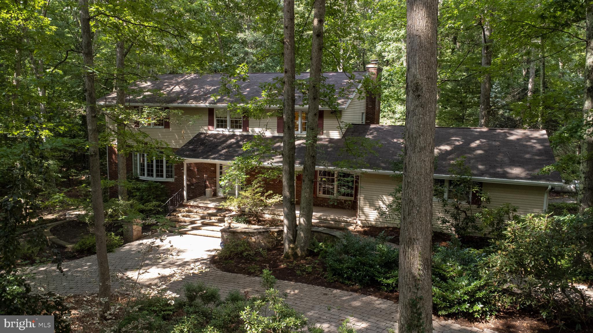 Relocate to peace & serenity in the hide-away setting of this unique 2-story perfectly positioned on 2.2 secluded wooded acres bordered by Patton Woods Natural Recreation Area. Although this home allows you to have your privacy it is also only an 8-minute drive to The Pennsylvania State University. As you walk through each room of the house peering out every window you will find breathtaking views of nature. Nearly 5400 sq ft of finished area, offering an enormous owners suite and adjacent owners bath, totaling 3 bedrooms and 3.5 baths. Enjoy the cozy fire with not one but two fireplaces! If that isn't enough, find yourself enjoying the roughly 2,400 sq foot room with radiant tiled flooring and walls of windows with endless possibilities! In addition to the attached two car garage there is also a large 3 car detached garage with a vast finished area above including electric and heat on the second floor. Priced to sell! Home being sold "AS-IS."