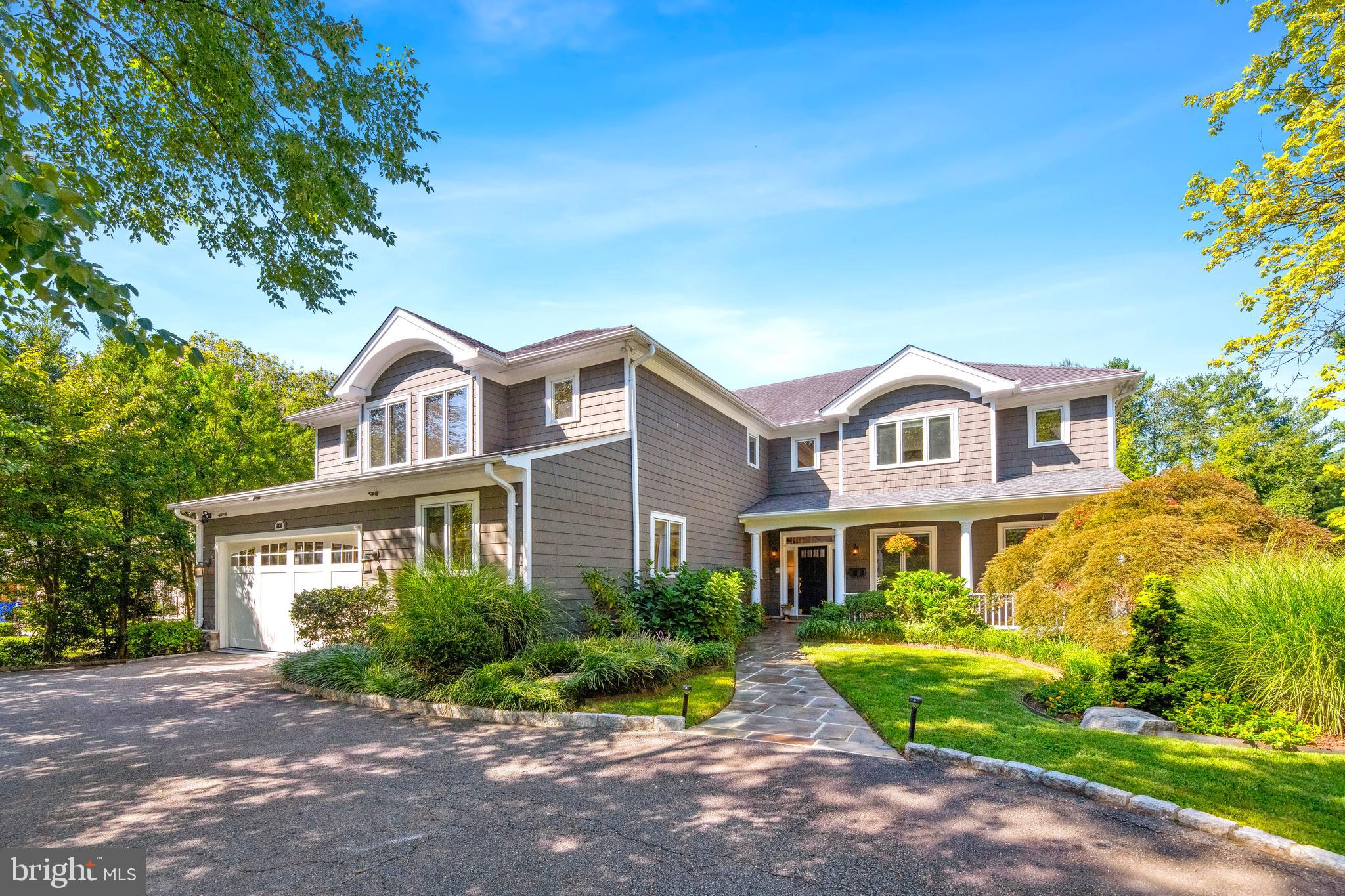 Built mostly new in 1999 as builder David Kelly's own residence, this 5-6BR resort-style craftsman is stunning year round but reigns supreme in the warmer seasons thanks to the gorgeous swimming pool with waterfall, 3-hole putting green, and phenomenal 60' deck overlooking the private rear grounds! Fabulous main level highlights include a dramatic 2-story entry foyer, an elegant living room with fireplace, a formal dining room with atrium door access to the deck, a gorgeous custom kitchen with center island and breakfast area, an adjacent 2-story great room with floor-to-ceiling stone fireplace and oversized windows, a library/family room with built-ins, a home office/possible future bedroom, an oversized powder room, and a terrific walk-in pantry. The upper level offers a luxurious owners' wing with sitting room, wet bar, luxurious bathroom, and two walk-in closets as well as 3 additional bedrooms and 2 additional bathrooms. The expansive walk-out lower level features a large recreation room/home theater with motorized room darkening shades and glass door access to the rear, a professional climate-controlled wine cellar, the 5th bedroom, a full bathroom, an exercise/guest room, and a laundry room with outdoor access. Extra interior/exterior amenities include surround sound speakers, a central vac, lawn irrigation system, and a 2-car garage. Convenient to downtown Bethesda and major travel routes and in the Burning Tree/Pyle/Whitman district, this is a dream home!