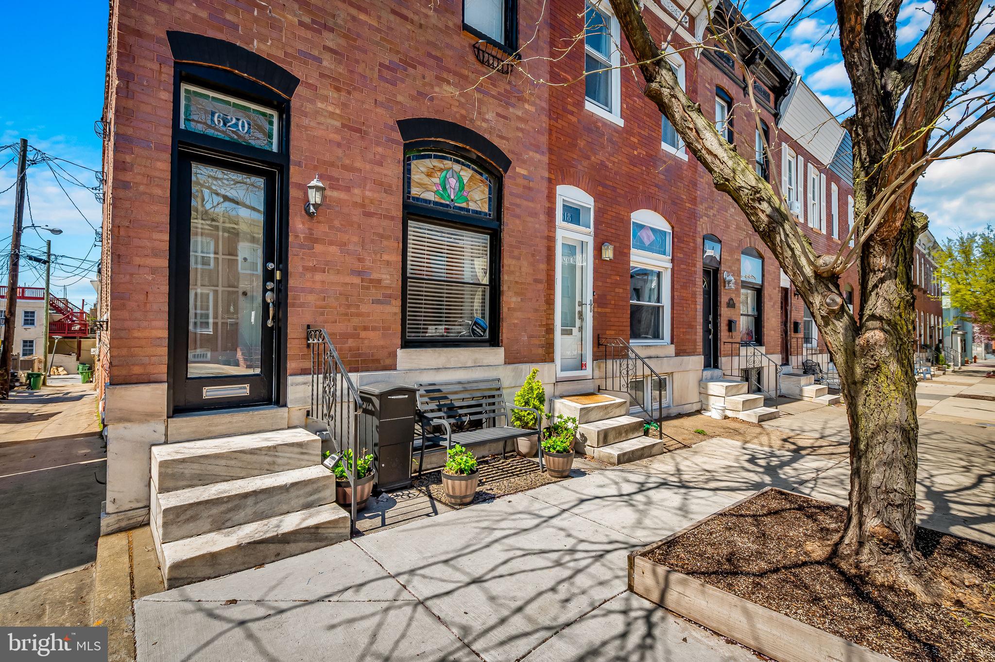 Stunning Canton end-of-group home with attached garage parking! The property boasts 2,352 sq. ft. of premier urban living space which has been renovated to seamlessly blend old world charm with modern amenities.  The home offers on the first level a dramatic, sun-filled open living/dining floor plan with a rear bonus room which accesses a cozy enclosed patio and a tiered roof deck.  On the second level there is an en-suite primary bedroom with window wall surrounds, eye-catching wall of built ins, large closet, primary bath with double sink vanity, glass enclosed walk-in shower, laundry area, secondary bedroom, and another full bath with a tub/shower.  There is a third bedroom, a full bath, and seating area in the generously sized lower level as well as additional storage, side entrance to alley, and inside direct access to the one car garage.  The home has been enhanced with crown moldings, brick accent walls, high ceilings, wood flooring throughout, a chef’s kitchen with stainless steel appliances, classic white cabinets, granite countertops, spacious island with cooktop, window treatments, five ceiling fans, and recently installed new dual zone HVAC.  A standout element of the property is the two-tier roof deck great for entertaining or casual relaxation.  The cityscape views from the upper deck are spectacular.  The property is desirably located within walking distance of Patterson Park, restaurants, shops, and cultural events.  The campuses of Johns Hopkins and University of Maryland, various schools, major highways, the stadiums, and various neighborhoods are easily accessible.