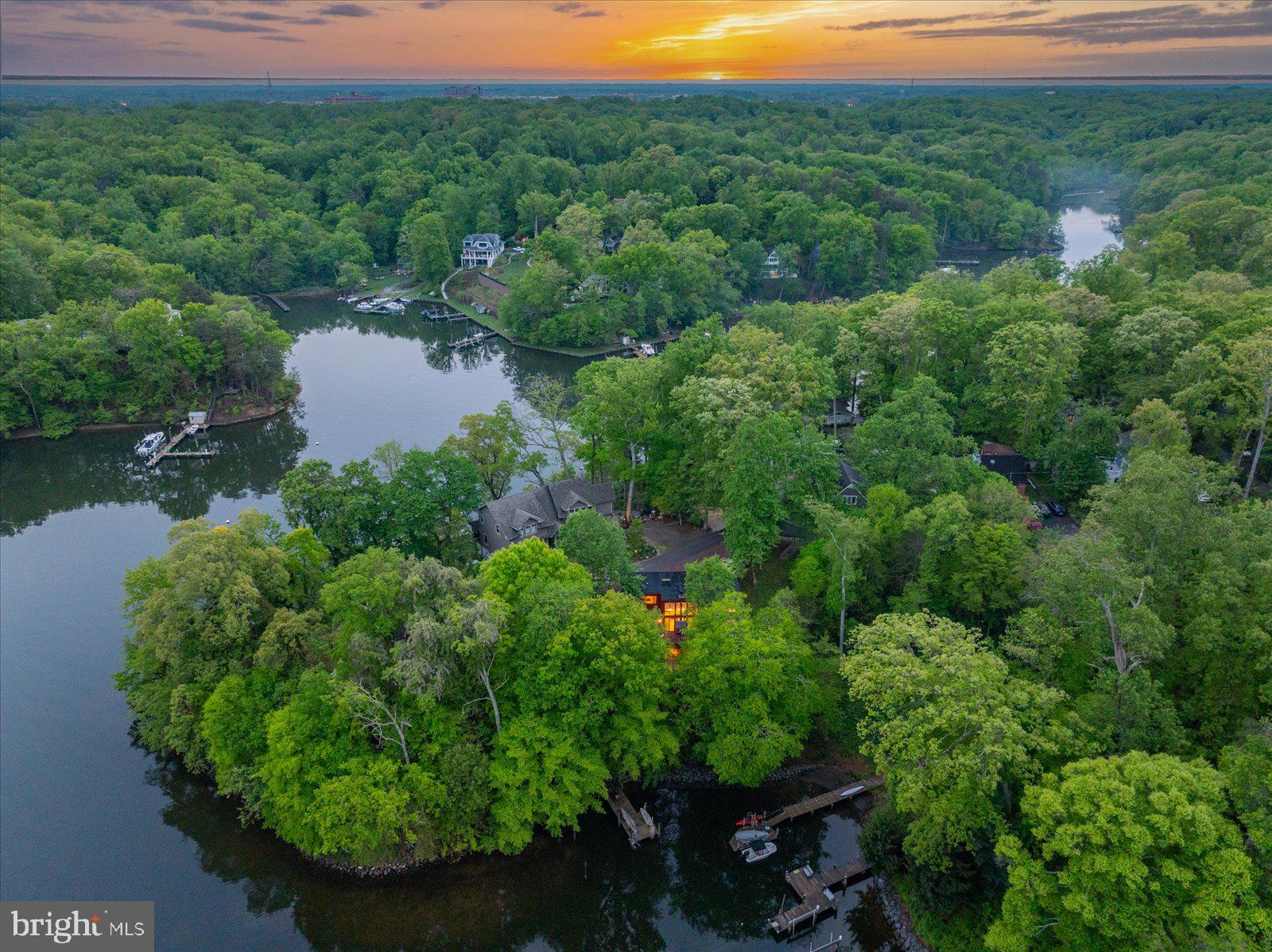 A rare offering in gated Epping Forest! This mid-century modern waterfront sanctuary rises above Saltworks Creek on a quiet protected cove—where timeless design meets an ethereal, peaceful connection to the water and outside.  Originally built in 1978, the almost 3600 sq. ft residence recently underwent a comprehensive renovation inside and out while honoring Mid-Century authenticity and maintaining an effortless flow and contemporary preference. From the street side, the home presents a timeless silhouette with a recent 70K Elevator with ramp that serves as a secondary entrance servicing 2 out of the 3 levels.   Waterside, the home is the ultimate expression of blurring the line between nature and interior with floor to ceiling glass walls, 8' sliding glass doors and unobstructed views from the deck.  This home wasn't designed to look at the water but rather live with it.  A massive stone central fireplace is the heart of the living area creating a cozy architectural retreat. Tasteful moderization but true to its mid-century roots, every element of the home has been considered preserving the architechural integrity while offering the comfort and convenience expected today.  More than a home, this is a rare opportunity to own a piece of design history- reimagined for modern waterfront living.   See documents for list of 925K spent on restoration since purchase including brand new private pier. Epping Forest is a Gated Waterfront Community on the Severn River with a community beach, waterfront clubhouse with restaurant and bar, tennis/pickleball and marina (new marina is currently under construction) Strong neighborhood connections where neighbors treat each other like family and fun happens weekly!  Year around community events codify friendships, 4th of July Fireworks, Oyster & Bull Roast, Boat Club, Summer Volleyball League, community chapel, yoga & summer camps. Come experience the best Chesapeake Bay Maritime Annapolitan Lifestyle around! Epping Forest Inc is a special benefit tax district with bylaws and binding rules and regulations with Non-Riparian Waterfront.  Special financing via Pentagon Federal Credit Jumbo 7/6 ARM available to low as 5.50%.