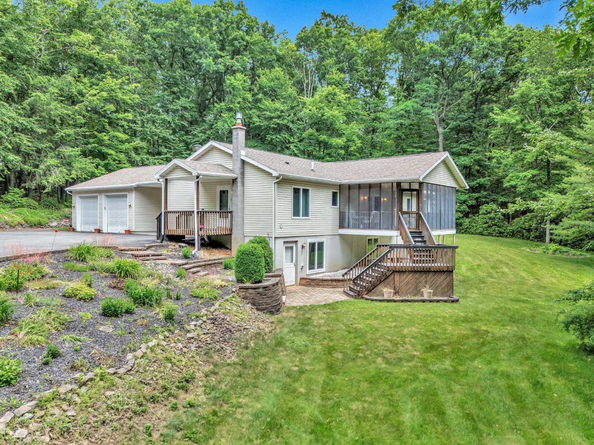 Now is the perfect opportunity to own a home in the woods and sit on the screened in deck to relax and hear the birds chirping. Kitchen has been upgraded and includes granite counter tops.   The hall bathroom is completely renovated.  The master bedroom has a walk-in closet. There is a 4th bedroom in the basement which is next to a large storage room. The utility room also in the basement is set up with rough plumbing for an additional bathroom.  The walkout basement has oversized windows and easy access to the outside.  Estimated size of home with basement included is approximately 2,700 square feet.  There is a generator for power backup and a propane heater in the basement as an additional heat source.   House is located about 5 minutes from Beltzville Lake and 10 minutes from St Lukes Hospital.  The Turnpike is approximately 5 miles away.  Property was appraised at $425,000.