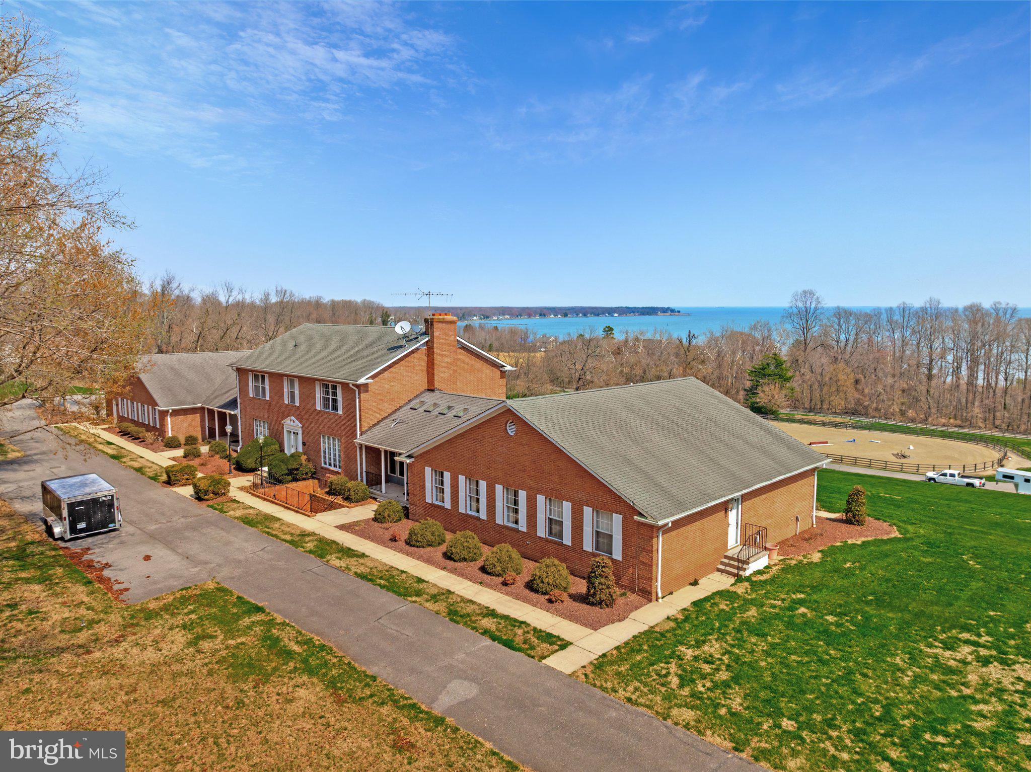 Have you ever dreamed of owning your own horse? This amazing farm may be just what you’re looking for. If you’re tired of the hustle and bustle of the city and need some peace and quiet to come home to we have the perfect spot for you. Worlds apart but still within close proximity to DC, Alexandria and Annapolis you can still commute to work during the week and relax on the weekends. 
Maryland Waterfront Properties is delighted to present an exceptional custom-crafted equestrian estate located in Tracys Landing, MD. This elegant property is thoughtfully designed around a symmetrical grand center hall and offers a total of seven spacious bedrooms, providing luxurious living with ample room for comfort and privacy. The first floor of the main residence features a convenient master suite and a dedicated office/library with its own private entrance, ideal for both productivity and relaxation. Additionally, the estate includes a separate in-law suite, offering privacy and comfort for guests or extended family members.This suite boasts breathtaking views of the Chesapeake Bay and is ideally situated near two local marinas, making it perfect for water enthusiasts. For those with equestrian interests, the expansive 13+ acre property is exceptionally well-equipped with a 125’x250’ riding ring and a well-appointed ten-stall barn. Despite its serene and private setting, the estate remains within convenient commuting distance to major metropolitan areas such as Annapolis, Washington D.C., and Baltimore, offering a perfect blend of rural charm and urban accessibility. This unique property truly combines the finest amenities with an atmosphere of casual elegance.
****Additional waterfront acreage available . Inquire with Listing Broker.***

If you are interested in learning more about this remarkable Estate, reach out to the exclusive listing broker Casey A. Sutherland with Maryland Waterfront Properties.