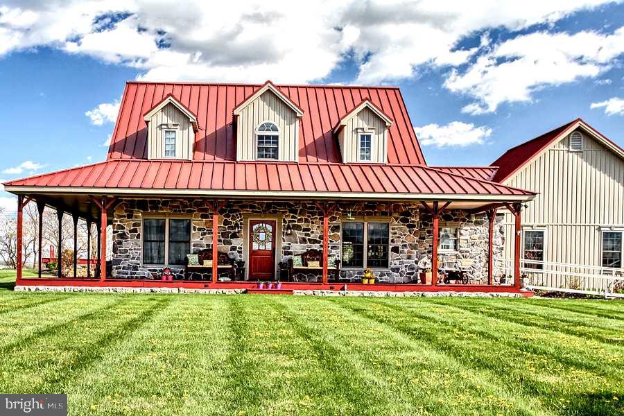 Your own piece of paradise! Beautiful custom built rancher on 3.85 acres w/breathtaking views of the countryside! Enjoy the open layout & lots of natural light in this 3BR/2.5BA home featuring Brazilian Cherry Flrs, vaulted ceilings, gourmet custom kit w/granite counters, flr to ceil stone fp & lg master suite. Landscaped pond w/fountain & gazebo, lg wrap around cov porch & patio + huge 40x60 detached Barn/Garage/Workshop. Handicapped accessible