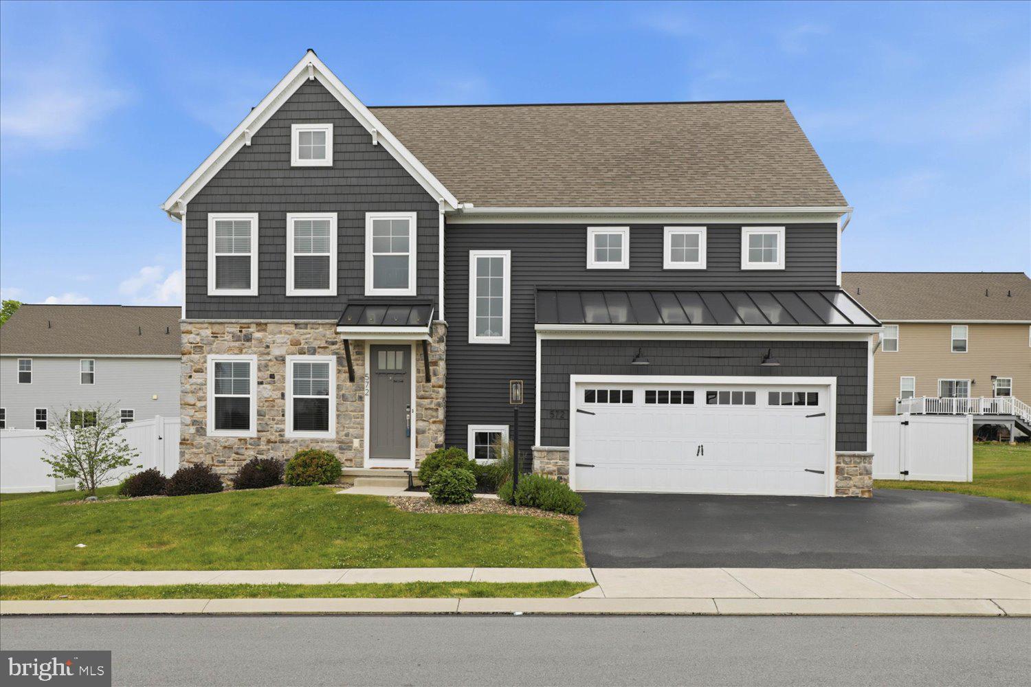 Welcome to 572 Nottingham Way, a stunning 4-bedroom, 2.5-bath home in the highly desirable Meadows at Bachman Run community in Annville. Thoughtfully designed and impeccably maintained, this home combines stylish finishes, modern conveniences, and inviting living spaces that are sure to impress.
From the moment you step inside, you'll appreciate the bright, open floor plan accented by beautiful architectural details, including wood archways, barn doors, shiplap feature walls, recessed lighting, and a striking black metal staircase railing. The heart of the home is the exceptional kitchen, featuring quartz countertops, a large center island, stainless steel appliances, abundant cabinetry, a corner pantry, and a spacious dining area perfect for everyday living and entertaining.
The adjoining living room offers a warm and welcoming atmosphere with a gas fireplace highlighted by a stone surround and shiplap accent wall. An office, half bath, and 9-foot ceilings throughout the main level add both functionality and comfort.
Upstairs, the spacious primary suite serves as a private retreat with a tray ceiling, walk-in closet, and a luxurious en-suite bath featuring a tiled shower and convenient access to the laundry room. Three additional bedrooms, a full bath, and the laundry room complete the second floor.
The finished lower level expands the living space and is ideal for entertaining, movie nights, or simply unwinding. Complete with recessed lighting, an electric fireplace, and a snack and beverage station, it's a space everyone will enjoy. There's also plenty of room for storage.
Outside, sliding glass doors lead to a private backyard oasis featuring a patio, white vinyl privacy fencing, and a cozy firepit area—perfect for gatherings with family and friends. A two-car attached garage and extended driveway provide ample parking.
Located in the Annville-Cleona School District and just minutes from major highways, shopping, dining, and everyday conveniences, this exceptional home offers the perfect blend of style, space, and location. Don't miss the opportunity to make it yours!