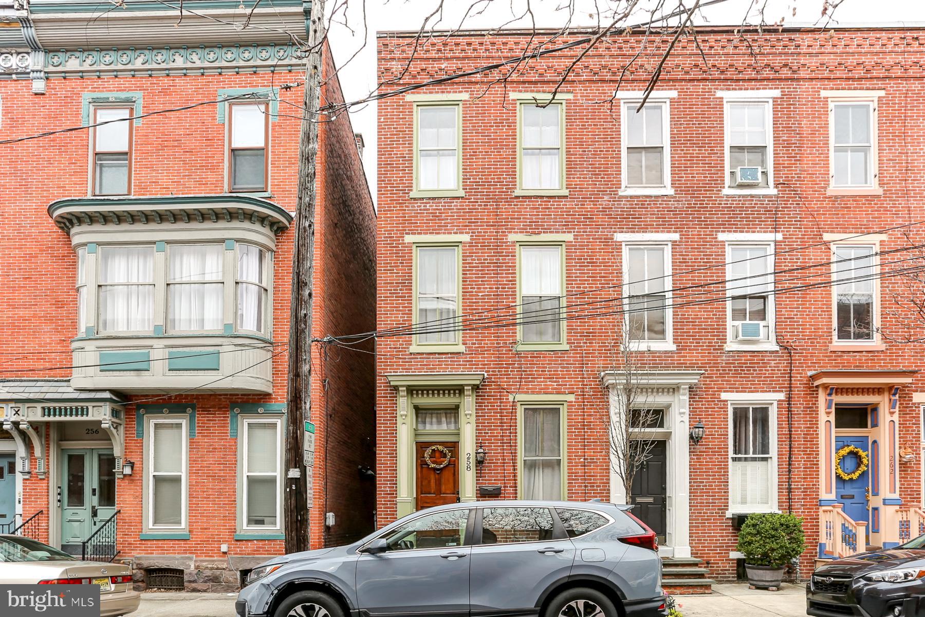 Nestled in the heart of  ever popular Historic Midtown, this delightful end-of-row townhome offers the perfect blend of classic character and charm with tasteful updates. The open-concept living and dining rooms feature high ceilings, chair rail and laminate floors, creating an inviting atmosphere that flows seamlessly into the stylish kitchen. With a heated, slate tile floor, exposed brick, chic white cabinetry, sleek concrete countertops and lots of recessed lighting, this cheerful kitchen is sure to please the cook!  High-end stainless steel appliances—gas oven/range, dishwasher, refrigerator, and microwave all remain with the home. The second floor features a spacious bedroom with double closet, and a cozy den, both with handsome pine floors. The full bath is a luxurious retreat, boasting a clawfoot tub, double sinks, and heated tile floor. The rear den/office highlights exposed brick and access to a private balcony, with composite decking - perfect for your morning coffee. Third floor offers two additional bedrooms, one with en-suite full Bath with shower, and heated tile floor. The fenced courtyard, flooded with natural light features a low-maintenance composite deck, ideal for relaxing or entertaining, No more propane tanks as there is also a convenient gas hookup for your gas grill! Efficient gas forced air heat and central air conditioning on first and second floors. Be a part of vibrant Midtown, just a few blocks to the Broad Street Market, the Millworks, Midtown Cinema, Midtown Scholar Bookstore, and Riverfront Park, yet NOT in the flood plain. Don’t miss the opportunity to make this wonderful home yours, TODAY!