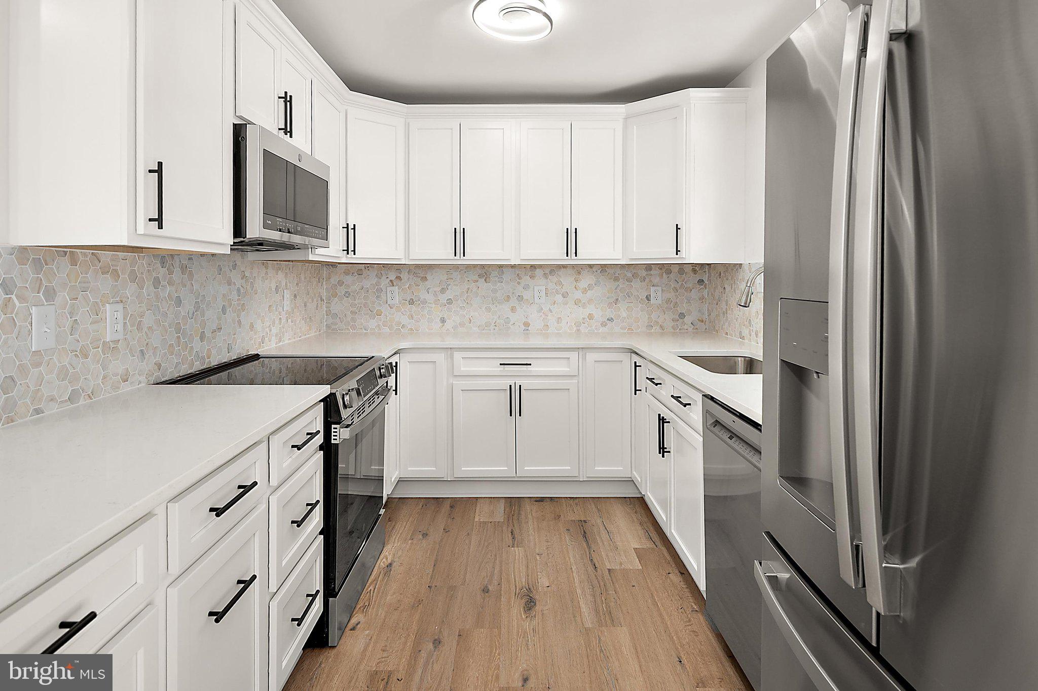 Welcome to 302 Franklin Ave, a beautifully renovated 3-bedroom, 2-bathroom single-family home in the heart of downtown Berlin.  This home is move-in ready and perfect as a primary residence, vacation getaway, or investment property. Step inside to a spacious family room featuring soaring vaulted ceilings and a cozy fireplace, creating the perfect gathering space to enjoy year-round. The newly renovated kitchen showcases stunning white cabinetry, a stylish tile backsplash, elegant quartz countertops, and stainless-steel appliances. Luxury vinyl plank flooring flows throughout the main living areas, while plush carpeting adds warmth and comfort to the bedrooms. The private primary suite offers an en suite bathroom, while two additional bedrooms provide plenty of space for family, guests, or a home office. Outside, you'll find a generously sized backyard with room for children and pets to play, gardening, or outdoor entertaining. Located in charming downtown Berlin, you'll enjoy easy access to local restaurants, unique boutiques, and the town's vibrant small-town atmosphere. Best of all, you're just a short drive from Ocean City's famous beaches and boardwalk, as well as Assateague Island State Park, where you can experience breathtaking natural beauty and the iconic wild horses. Don't miss this opportunity to own a beautifully updated home in one of the Eastern Shore's most desirable locations!