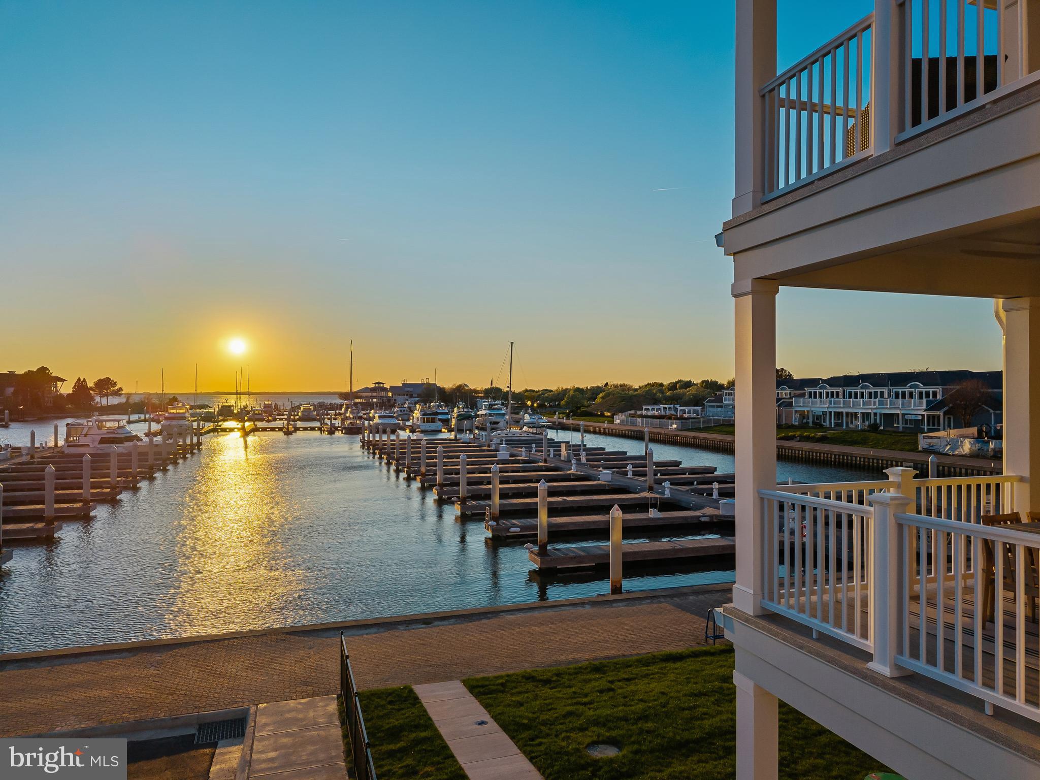 Welcome to Sunset Wharf, a refined waterfront enclave set within the picturesque Bay Bridge Marina, where coastal living is defined by sweeping views and effortless sophistication. This fully completed residence is one of just a select offering within the initial collection of three buildings, each thoughtfully designed with only two residences each, creating an intimate and private setting along the water’s edge.

Inside, the home unfolds across three levels with a thoughtfully designed four bedroom, four bath layout that offers both flexibility and comfort. A private bedroom and full bath on the entry level provide the perfect space for guests or a quiet home office. The main living level is designed for seamless everyday living and entertaining, highlighted by a warm and inviting living room with a gas fireplace that adds both comfort and ambiance. The upper level features two additional bedroom suites, including a serene primary retreat complete with its own gas fireplace. An elegant touch that enhances the sense of relaxation and retreat.

Expansive windows frame captivating views over the marina and out to the Chesapeake Bay, filling the home with natural light and creating an ever-changing backdrop of boating activity and open water. As the day winds down, the setting truly comes to life with breathtaking sunsets that paint the sky and reflect across the water. An experience to be enjoyed from both the interior living spaces and outdoor areas.

High-end finishes and a modern, open-concept design elevate the interiors, while the beautifully appointed gourmet kitchen and well designed baths enhance both form and function. Every detail has been curated to deliver a low-maintenance, lock-and-go lifestyle without compromising on luxury.

Ideally positioned within walking distance to waterfront dining, including Libbey’s Coastal Kitchen & Cocktails and Knoxie’s Table, residents also enjoy immediate access to marina amenities, scenic walking paths, and the relaxed rhythm of life on the Bay. Sunset Wharf offers a rare opportunity to own a newly completed residence in a thoughtfully designed waterfront community where every day feels like a getaway. Welcome Home!