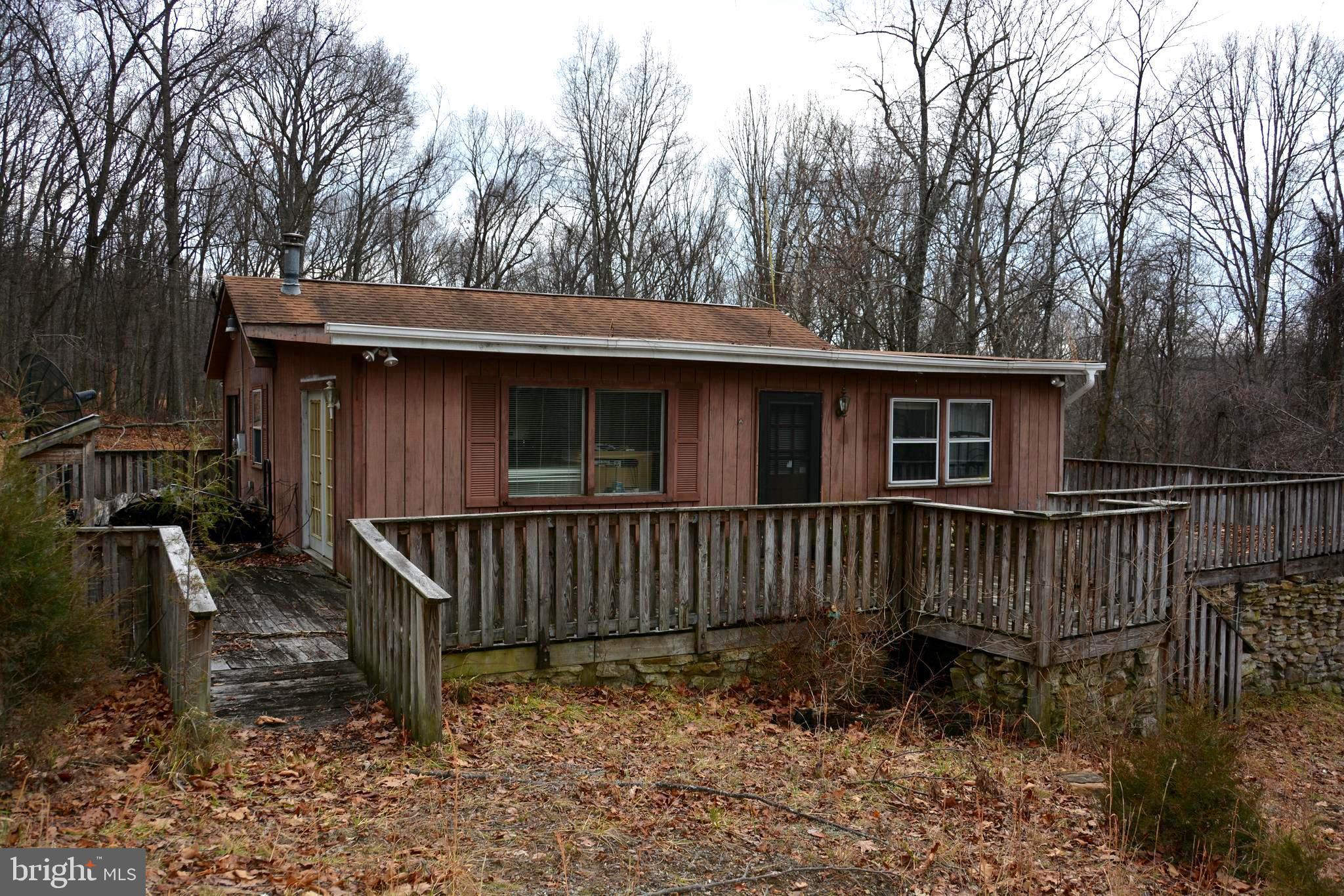 Buffalo Ridge Ranchettes.  About 15 minutes from Capon Bridge, WV.  The home has some neat features.  Wide deck wraps on 3 sides.  Vaulted ceiling in the dining, kitchen area.  Fairly spacious, feels much larger inside that it appears from the outside.  This is a fixer upper and will require a cash purchase or potentially a re-hab loan.  Woodstove offers supplemental heat.  The HOA is no longer in operation.  The road system is not State or County maintained.  The property does have well, septic.  Perfect for the handyman looking for a  weekend project, getaway.   Wooded, fairly level 2.2 acre lot.