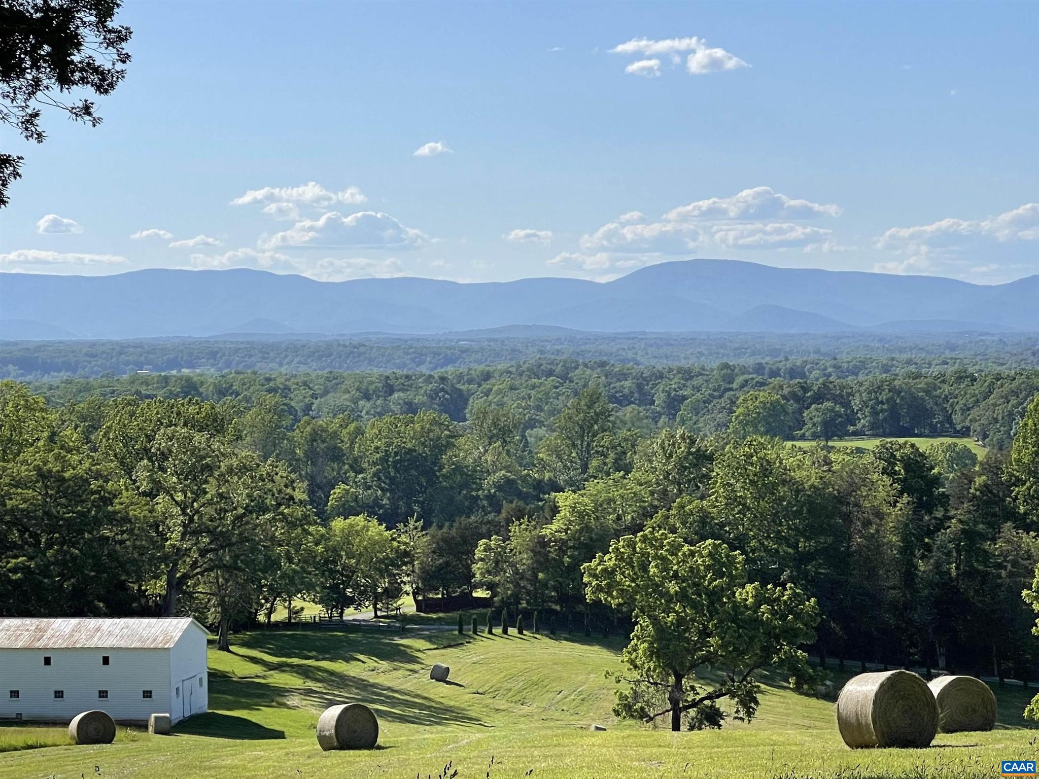 Discover the charm of this picturesque 42-acre farm, just a scenic 10-mile drive from Charlottesville. Nestled amidst rolling pastures and tranquil woodlands, this property boasts a serene creek meandering through its expanse, alongside an enchanting antique farmhouse (c.1908). Step inside to find a tastefully updated kitchen, featuring modern wood cabinets and stainless steel appliances, complemented by three beautifully renovated bathrooms and four generously-sized bedrooms. Breathtaking elevated plateau, offering panoramic vistas of the Blue Ridge Mountains. Wake up to awe-inspiring sunrises and winding down with stunning sunsets from your future dream home perched on this majestic vantage point. Additionally, the property features a substantial barn, perfect for various agricultural pursuits, making it an ideal setting for those seeking a manageable-sized farm with the convenience of close proximity to town.,Fireplace in Family Room