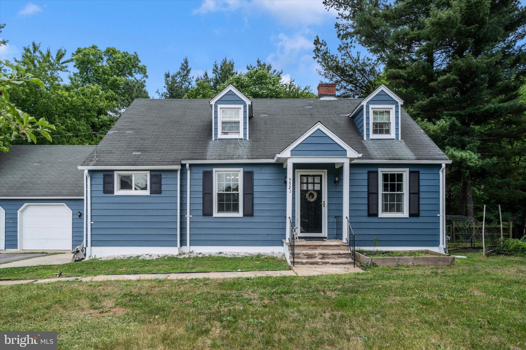 This charming Cape Cod with a detached 2-car garage is nestled on a picturesque 0.38-acre wooded lot in sought-after Ellicott City! This unbeatable location offers close proximity to Columbia, allowing easy enjoyment of trails, shopping, dining, parks, and many of Columbia’s sought-after amenities.  This home features 4 bedrooms, 3 full bathrooms, and timeless character thoughtfully blended with modern updates throughout. Gleaming hardwood flooring welcomes you into the light-filled main level featuring a spacious living room, formal dining room, and an updated kitchen complete with granite countertops, tile backsplash, and gas cooking. Two main-level bedrooms and a full bathroom provide flexible living options, while the upper level offers additional generously sized bedrooms and an en-suite bathroom.  Enjoy year-round relaxation in the enclosed porch with vaulted ceilings overlooking the peaceful backyard and mature trees. The finished walk-out lower level expands the living space with a large recreation room, full bathroom, and abundant storage space.  Additional highlights include energy-efficient replacement windows, a Carrier HVAC system, and a large and spacious 2-car garage. Perfectly situated with convenient access to Rt 100, I-95, and Rt 29, this home offers the perfect combination of charm, space, land, and modern updates in a spectacular Howard County location!  This home is in need of some TLC and is priced accordingly.