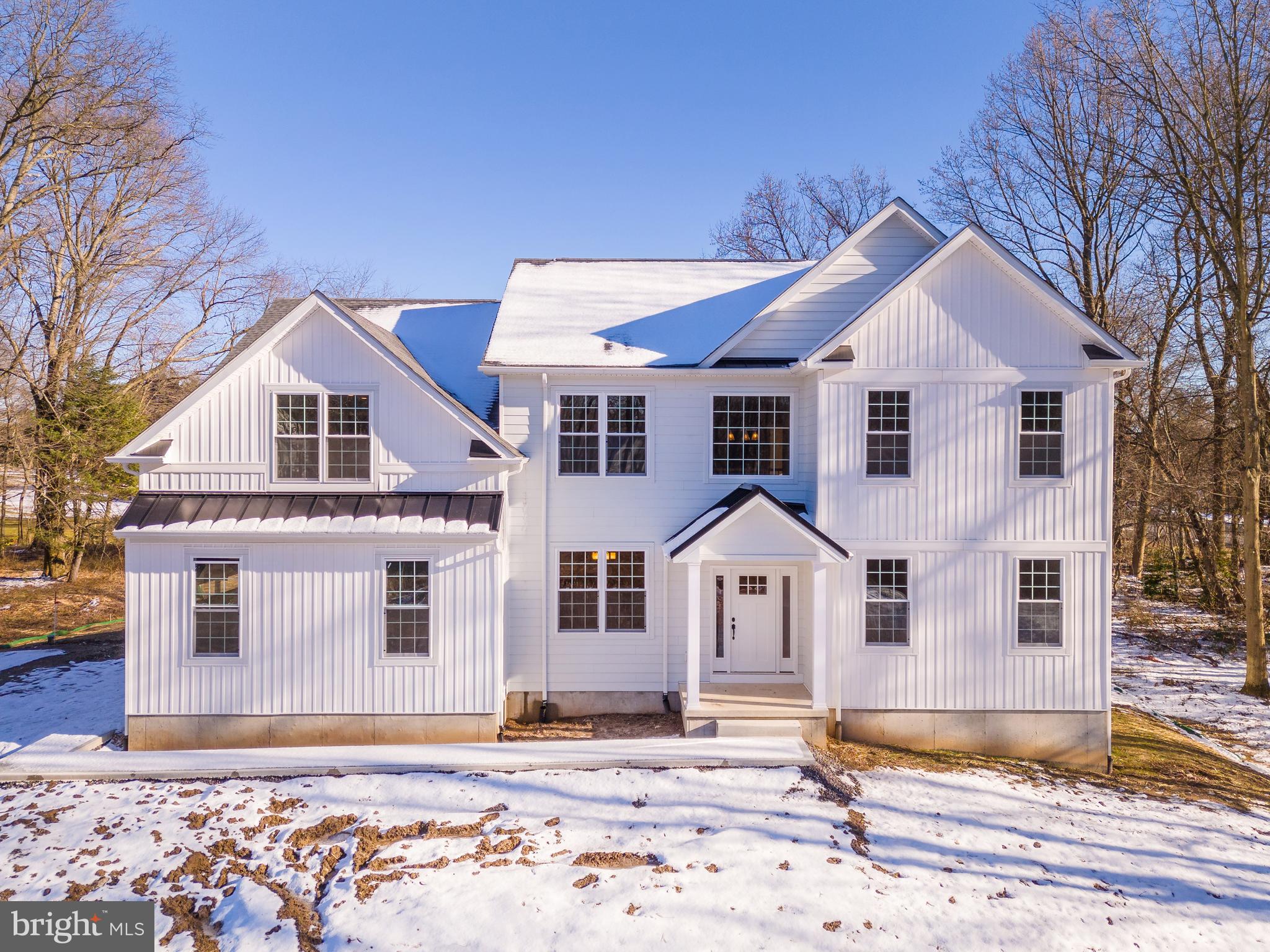 1070 Bristol Rd is the LAST AVAILABLE homesite at this remarkable new development, 'The Estates at Bristol Pond.' Standing as a custom single-family home community of just THREE exclusive luxury residences, it is situated around a picturesque pond, promising to be one of Bucks County's most serene settings. 
-LOT #3- QUICK DELIVERY - (Base price: $1,049,900 | Pre-selected options value - $188,025 | Valued At - $1,237,925). 
Sitting on 1 acre of land with an unimaginable vista of what came to be known as Bristol Pond, this stunning property offers a 4-bedroom, 3 1/2-bathroom Modern Farmhouse home with a fully finished daylight basement and an oversized elevated Trex deck. Screaming with curb appeal, the white vertical siding with accent black metal roofing will stand out as soon as you pull into the community. With plenty of parking space on the massive driveway.  As you walk inside, be in awe of the towering 2-story foyer and notice the gleaming wide plank red oak hardwood flooring and matte black hardware accents. A living room sits to the right and a formal dining room boasting large windows to your left. Dining room sits adjcent the beautifully designed gourmet kitchen with 42" custom wooden cabinets fitted with white quartz countertops. An oversized island with matching quartz and a dual-sided waterfall edge acts as a centerpiece of this remarkable space. The kitchen also features a Samsung stainless steel appliance package, vented hood, recessed Sharp microwave, undermount stainless steel sink, and gooseneck faucet all accented with matte black handles and pulls. Spanning out of the kitchen is a breakfast area with a slider leading out to the backyard Trex deck. Enjoy a cup of coffee while you gaze at the expanse of pure Bucks County serenity. A massive family room opens up with a vaulted ceiling and sports a gas-burning fireplace as well as a plethora of large windows allowing for the ample flow of natural light. The remainder of the first level holds a large private workspace, powder room, and laundry room with an Au-pair side entry door. One of the other main highlights of the main level is the floating open riser solid oak staircase, fitted with matte black metal spindle railings; matching the matte black door hardware throughout the home. Make your way up to the second level to find an expansive loft area, perfect for the kids' homework desks, play area, or library. Through the French doors awaits the spacious owner's suite, where you will immediately notice the tall tray ceiling.  A sitting room with multiple closets overlooks the front of the home. Look out onto the pond from the comfort of your lavish bedroom. The owner's bathroom is tiled from floor to ceiling and holds a double free-floating European vanity, free-standing soaking tub, and a glass shower stall with a bench. Top-of-the-line Grohe plumbing fixtures add extra flair to the room. Bedrooms 2, 3, and 4 are all ample-sized with excellent closet space; each room was designed to fit a king-sized bedroom set. Don't miss the hallway bath fitted with textured ceramic tile, a double vanity, soaking tub/shower, and Grohe fixtures. The lower level is a  massive finished space that could be imagined as an entertainment mecca with the ability to build out a game room, theatre, fitness room, bar, and more. An array of daylight windows gives the lower level an abundance of natural light. A full bathroom is perfect if you will require a spa or extra living quarters. Other notable features include loads of closet space, 2-car garage, multiple heating zones, a tankless hot water heater, well water system, energy-efficient Jeld-Wen windows, and Therma-Tru doors. This property holds too many features to name. Find yourself just minutes away from all of the shops and popular dining spots. Outdoor experiences at the Churchville Nature Center and the newly completed 'Rails to Trails' park is within walking distance. Schedule a private tour today!
