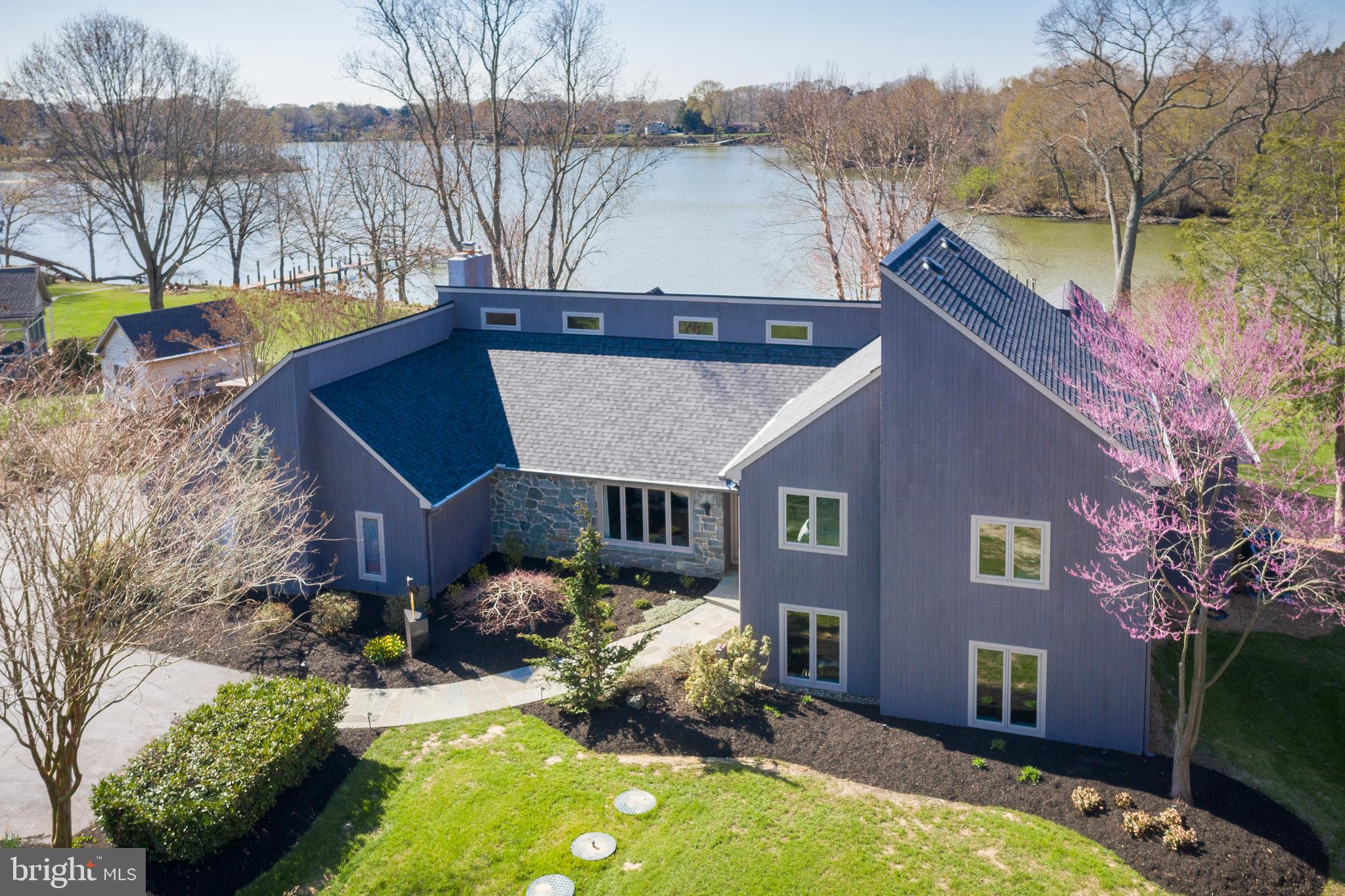 Breathtaking waterfront on the Wye River!
Panoramic water views from this completely updated contemporary home!
As you meander down the treelined driveway of this 1.7-acre property you will be struck by the beautiful landscaping and enchanted by the sounds of nature. Privacy grows as your approach the home, and views of the iconic Wye River come into focus. This is just the beginning of this storybook home.   
Inside the property you’ll be greeted in a lovely well-lit foyer. Off to the left on the main level you will discover a large family room with vaulted ceilings, a stone fireplace, and water views. A great space to gather as it is adjacent to the fully updated gourmet kitchen with stone and stainless beautifully complimenting the space. If you head downstairs, you’ll find a generous space currently used a 2nd family room, as well as a dedicated workout area and a half bath. From the main entry as you go up a half level, you’ll enter a remarkable primary bedroom and bath. Elevate another few steps to find 3 spacious additional bedrooms and full bath. Views through the home are gorgeous, and with the southwesterly exposure the sunsets are like icing on the cake! 
There are many updates including Pella windows (2015), a BAT nitrogen septic system with 4-bedroom capacity (2021), two heat pumps (2018), timber tech and screened porch (2017), 40 year architectural shingles (2020), renovated kitchen (2020), new carpet, finished hardwood floors, renovated bathrooms and much more!
The fun doesn’t stop there because the grounds of this property are beautiful! The gardens are professionally landscaped, there is a private boat launch/ramp, private pier, and a 12.5K boat lift. While at the property you’ll feel the beauty of a private, quiet and secluded location but you’ll also find that it’s convenient to the bay bridge, shopping of all kinds, & close to Bennet point store. Don’t miss this opportunity to live on the Wye within the walls of this stunning home.