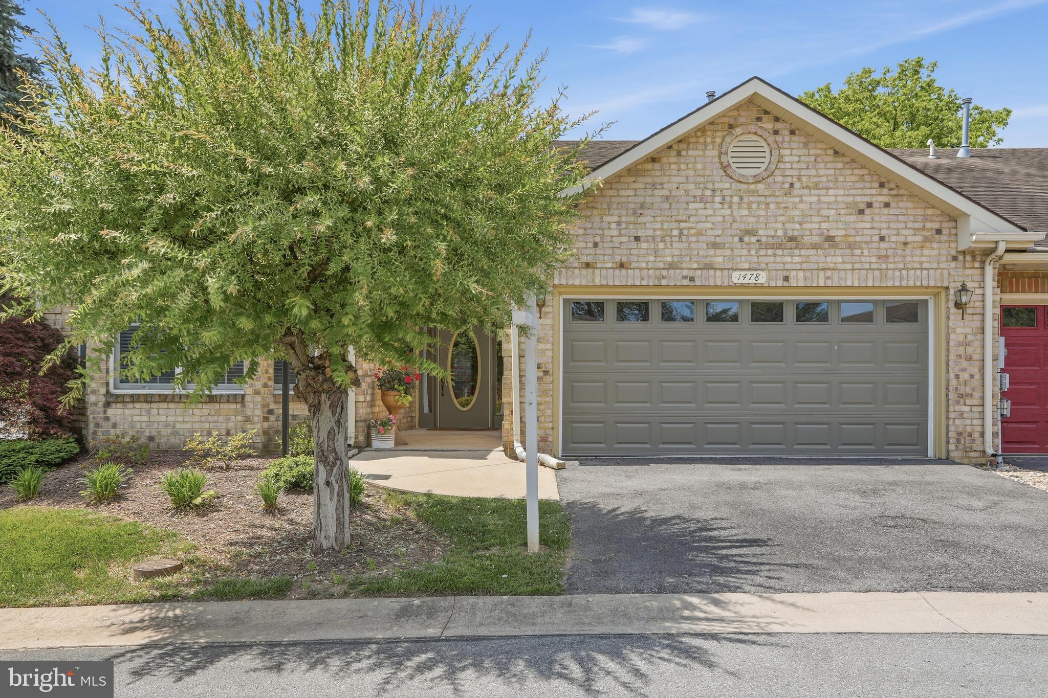 NEW LISTING!  Welcome home to this inviting one-level retreat featuring soaring vaulted ceilings, a cozy double-sided fireplace, and beautiful hardwood floors. With 2 spacious bedrooms, 2 full baths, and an oversized attached garage, this home offers comfortable, easy living. The generously sized primary suite includes a walk-in closet and handicap-accessible design, while the second bedroom is filled with natural light and ample closet space. Enjoy your morning coffee or evening relaxation on the private stone patio, surrounded by lush evergreens and garden plantings that create a peaceful, secluded setting. Ideally located just steps from the community pool, clubhouse, tennis courts, park, and scenic walking trails, this charming home combines comfort, convenience, and a welcoming neighborhood atmosphere.