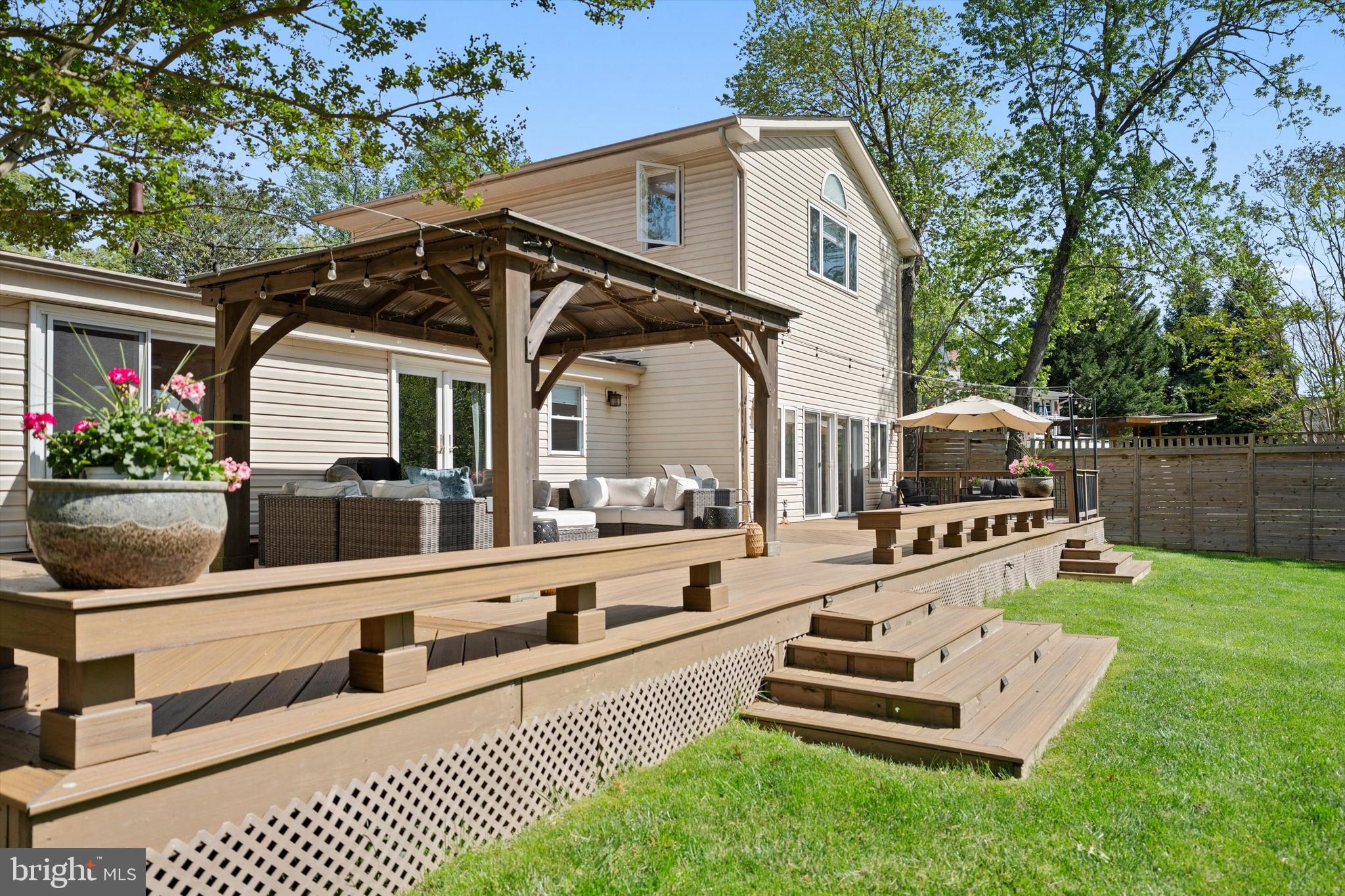 Welcome to this exceptional home, set on a quiet half-acre lot and thoughtfully expanded and renovated throughout. Blending modern updates with comfortable, everyday living, this residence offers incredible flexibility for both relaxing and entertaining—indoors and out.
The expansive main level features rich hardwood floors and a warm, inviting layout. At the heart of the home is a spacious kitchen with an oversized island and bright breakfast area—perfect for gathering with family and friends. A large dining room, cozy sitting room, and family room with fireplace and sliding doors to the backyard create multiple spaces to unwind or host with ease. The main level also includes a convenient laundry room and five generously sized bedroom suites, each with its own private bath, one of which is standout guest suite with sliding doors opens directly to the deck, offering comfort and privacy for visitors.
A unique two-story studio with a separate entrance adds even more versatility, complete with a wet bar featuring an oak countertop and an upper-level loft—ideal as a creative space, home office, guest retreat, or optional seventh bedroom. This flexible area provides endless possibilities to suit a variety of needs and lifestyles.
Upstairs, the primary suite provides a peaceful retreat, featuring a custom-designed walk-in closet and large windows that fill the space with natural light while offering beautiful, serene views. The spacious layout creates a true sense of privacy and relaxation at the end of the day.
Step outside to a very large, newly built deck with a charming gazebo, overlooking a spacious fenced backyard—perfect for outdoor dining, entertaining, or simply enjoying quiet moments in a private setting. 
The expansive yard offers plenty of room for play, gardening, or future outdoor enhancements.
Ideally located inside the Beltway, this home offers both tranquility and convenience, with easy access to major commuter routes, shopping, dining, and top-rated schools. A rare combination of space, versatility, and location, this home is truly designed to grow with you and adapt to your lifestyle.