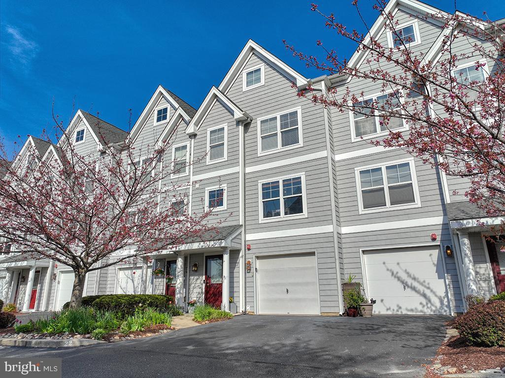 Serene Canal-Front Retreat in Rehoboth Beach – Fully Furnished & Rental-Friendly
Discover a serene coastal oasis perfectly situated along the Rehoboth-Lewes Canal, offering privacy, tranquility, and lush natural surroundings—all just steps from the vibrant heart of Rehoboth Beach.  Nestled among mature trees and beautifully landscaped grounds, this light-filled, freshly painted 4-bedroom retreat is offered fully furnished and features bright, multi-level coastal living with no short-term rental restrictions, making it an ideal opportunity for both personal enjoyment and investment.

Enjoy a variety of peaceful outdoor spaces, including a walkout patio, screened porch, and treetop-level balcony—all surrounded by greenery and canal views. The home is located in an intimate, amenity-rich community with low HOA's  featuring Rehoboth’s only heated pool, a large dock, fire pit, canal-side walking trails with benches and picnic areas, and expansive green lawns shaded by mature trees.

Inside, the four-level home offers two luxurious primary suites, two additional guest bedrooms, three full baths, a powder room, and an attached garage with additional assigned off-street parking. The first-floor primary suite opens directly onto the patio and green space—just steps from the pool and dock—offering a spa-like private escape. The main level boasts an airy, open-concept living and dining area, and a bright eat-in kitchen with stainless steel appliances, pantry, breakfast bar, and full dining space—perfect for casual meals or festive gatherings. The screened-in porch extends your living area outdoors—ideal for morning coffee, cocktails, or al fresco dining.

Upstairs, the second primary suite features a walk-in closet and private balcony—perfect for sunrises, stargazing, or quiet moments. A third guest room (or home office) with sitting area and full bath is just down the hall. On the top level, a light-filled loft with fireplace offers flexible space for an oversized bedroom, bunk room, gym, game room, or creative retreat.

This ideally located, low-maintenance home is within walking distance to downtown Rehoboth’s acclaimed restaurants, boardwalk, beaches, and entertainment. Launch a kayak or paddleboard from the dock out back, or bike the Junction & Breakwater Trail to Lewes via Cape Henlopen State Park—just across the street.

Whether you're seeking a fun-filled beach escape, a primary coastal home, or a high-performing investment property, this well-priced gem checks every box. Summer 2025 is just around the corner—don’t miss your chance to own this exceptional Rehoboth Beach retreat!  Check out the attached video and schedule your private tour today!