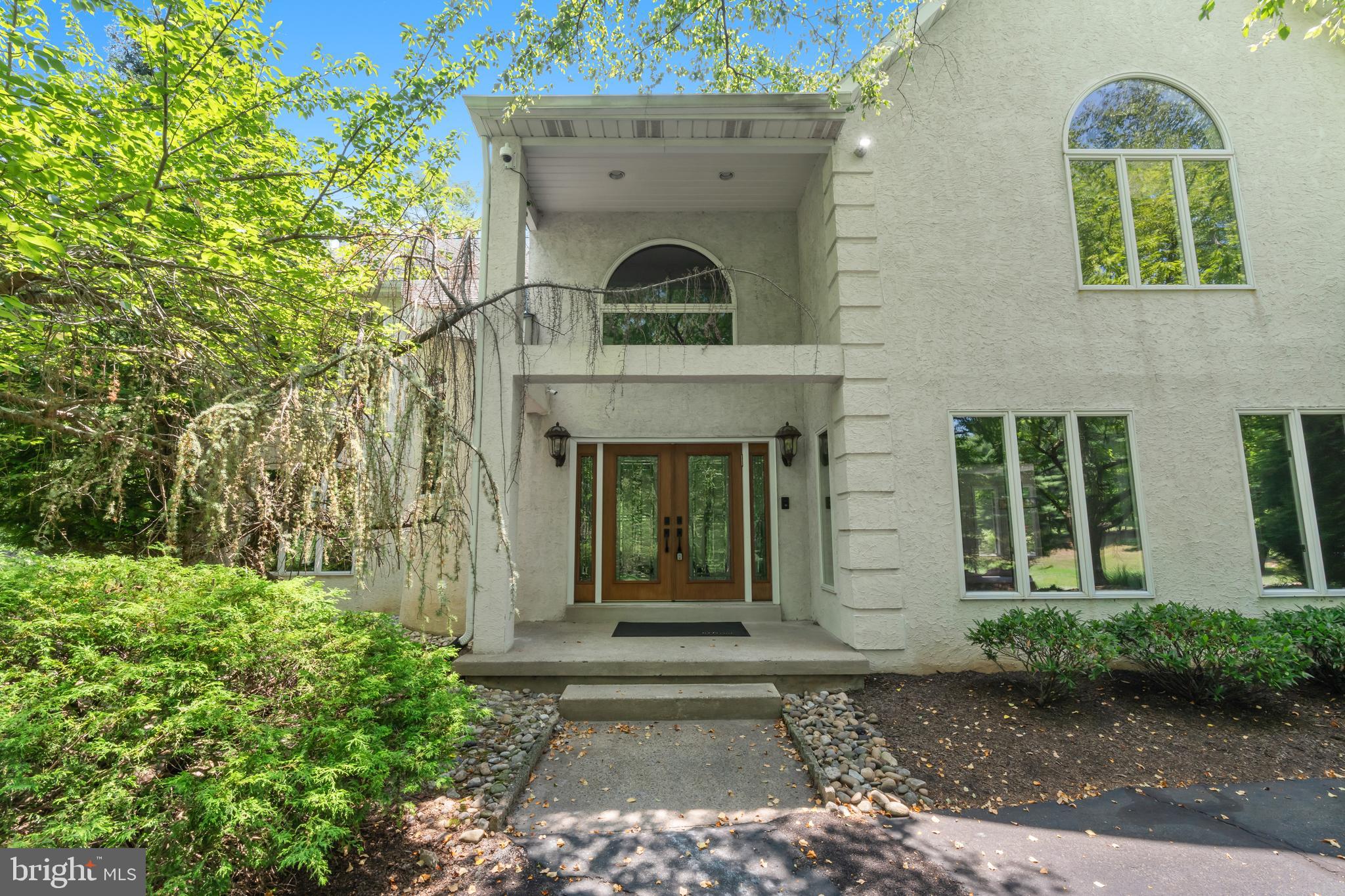 Nestled at the end of a peaceful cul de sac, this exceptional five bedroom residence offers the perfect blend of refined elegance, everyday comfort, and resort style living. A grand double door entrance welcomes you into an impressive two story foyer highlighted by a sweeping curved staircase that immediately sets the tone for the home's sophisticated design.

Sun drenched living and dining spaces feature soaring ceilings, updated flooring, and an open, flowing layout ideal for both entertaining and everyday living. At the heart of the home, the chef's kitchen is beautifully appointed with abundant cabinetry, a spacious center island, and seamless access to the inviting family room. Warm and welcoming, this oversized gathering space features a fireplace, custom wet bar, and a dramatic wall of windows that frame breathtaking views of the backyard oasis.

The main level also includes a versatile fifth bedroom, perfectly suited as a private home office, guest suite, or flex space. Upstairs, four generously sized bedrooms provide comfortable accommodations, including a stunning primary retreat designed for relaxation. Vaulted ceilings create an airy atmosphere, while a cozy fireplace adds warmth and charm. Sliding glass doors open to a private deck complete with an awning, creating the perfect spot to enjoy your morning coffee or unwind in the evening. The luxurious spa inspired bath offers a tranquil escape from the everyday.

Step outside and discover a backyard that rivals a private resort. Set on an expansive and secluded lot, the outdoor living experience is truly extraordinary. Spend summer days lounging beside the sparkling pool, hosting gatherings on the patio, or simply enjoying the privacy and beauty of your surroundings. With ample space for recreation, pets, and gardening, this outdoor sanctuary offers endless possibilities for enjoyment.

Additional highlights include abundant storage, a three car attached garage, and an extended driveway providing ample parking for guests. Conveniently located near shopping, dining, and major commuter routes, this remarkable property delivers the perfect combination of luxury, privacy, and lifestyle in one unforgettable setting.