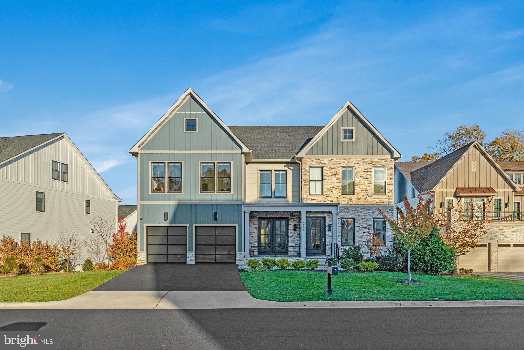 Introducing 1353 Monitor Lane — a stunning, 4-year-young, 6-bedroom, 6.5-bath home that blends timeless farmhouse architecture with modern luxury across four beautifully finished levels. Thoughtfully designed with an open-concept layout, 10-foot ceilings on both the main and lower levels, and abundant natural light, this residence has been impeccably maintained by its original owners.  The main level welcomes you with engineered hardwood floors, a formal dining room, and a private study/office/den ideal for working from home. The gourmet kitchen showcases a Sub-Zero refrigerator, Wolf wall ovens, and a Wolf professional 6-burner range with a convenient pot filler above the cooktop. An expansive quartz island comfortably seats five, while a walk-in pantry and butler’s pantry with beverage refrigerator provide exceptional storage and prep space. The kitchen connects directly to the bright breakfast area and expansive family room anchored by a 60-inch linear Primo gas fireplace. Step outside to the deck, where a 12-foot stainless steel outdoor kitchen awaits—complete with an outdoor-rated refrigerator, professional power burner, and granite countertop—perfect for entertaining, dining, and gatherings. The mudroom off the garage includes drop zone cubbies, offering a practical and organized transition space for busy households. Upstairs, discover four spacious bedrooms, each with an ensuite bath. The primary suite is a true gem, featuring a sitting area, two large walk-in closets with custom built-ins, and a spa-inspired bath with a glass-enclosed rain shower, soaking tub, and dual vanities with abundant counter space. A central loft area offers flexible use as a study, reading nook, homework zone, or casual lounge, while a laundry room with sink, cabinetry, and folding area completes the level. The third floor presents an additional flexible loft area—ideal as a home office, playroom, or media room—with rough-in plumbing for a future wet bar. This level also includes a fifth bedroom with ensuite bath and access to a large, partially covered rooftop deck for outdoor enjoyment. The fully finished walkout lower level—with 10-foot ceilings—features a sixth bedroom, full bath, and spacious recreation area, along with multiple storage options. From here, step out to the outdoor patio anchored by a stone fire pit with a surrounding seat wall—perfect for evening gatherings or quiet relaxation under the stars. Additional highlights include electric vehicle charging station in the garage, approximately $100,000 in enhanced landscaping for year-round appeal and $25,000 in integrated security, home automation, and surround sound upgrades. Custom Smith & Noble window treatments include motorized blinds in the primary suite and portions of the family room, offering effortless comfort and privacy. Privately tucked away in the Retreat at McLean and Mehr Farm subdivision, this sought-after residence enjoys a premier location within the McLean High School pyramid.   The home offers unbeatable access to major commuter routes, including Route 123, the 286 Toll Road, I-495, I-66, and the George Washington Parkway, making travel to Washington, D.C., Northern Virginia, and Maryland easy and convenient. You're just minutes from Tysons, the Pentagon, and various shopping, dining, and entertainment options. Tucked away on a quiet street with a cul-de-sac but also easy access to Route 123 and Old Dominion Dr, the home combines peaceful surroundings with everyday convenience. This is an opportunity you won’t want to miss!