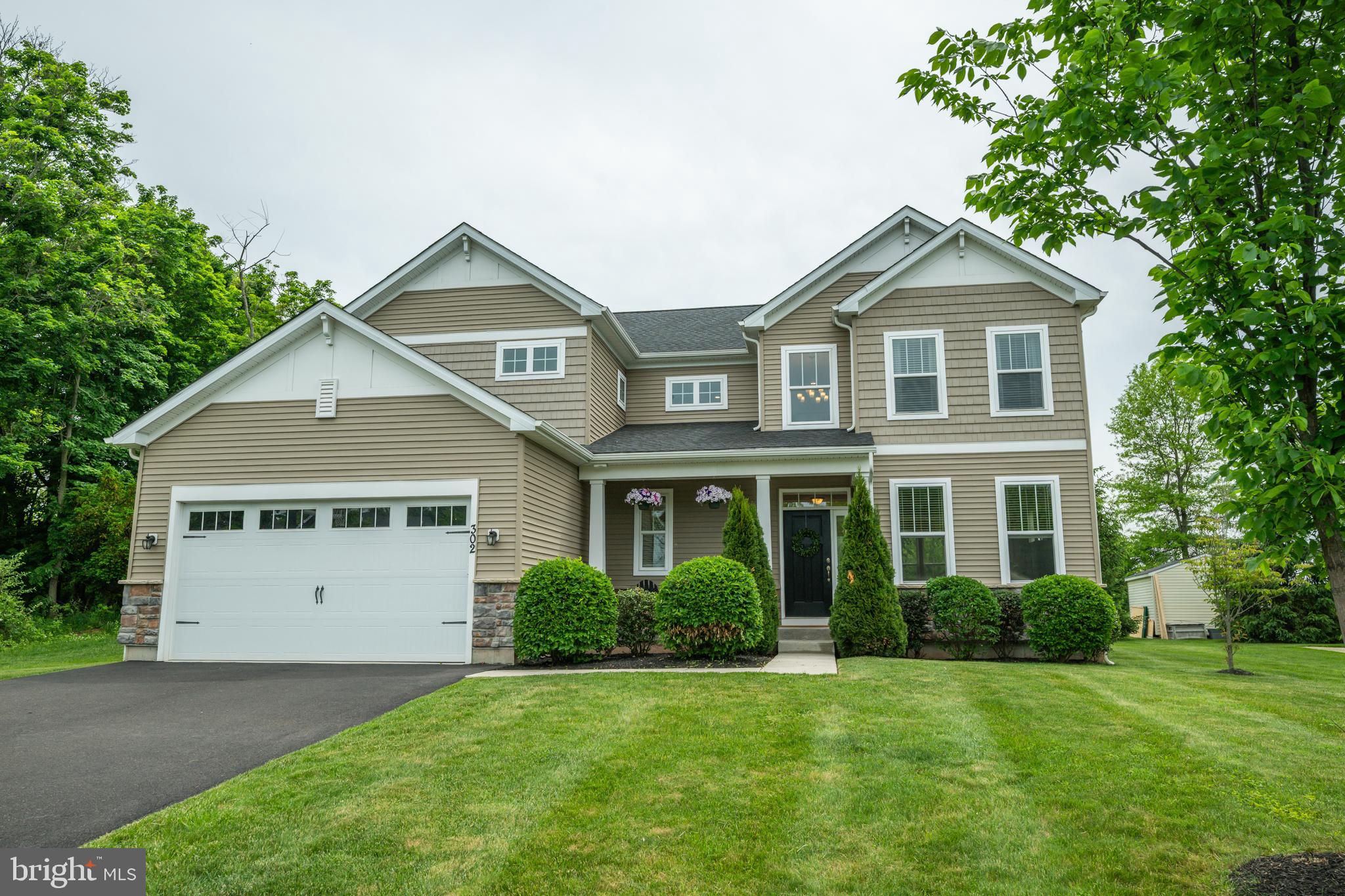 Welcome home to this STUNNING home located in the highly desirable Hidden Meadows community of Perkasie Boro! Positioned on a premium lot with only one direct neighboring home and newly built in 2020, this home offers a rare sense of privacy paired with the perfect blend of elegance, comfort, and modern functionality. Freshly manicured landscaping guides you to your covered front porch - the perfect place to enjoy your morning coffee. Step inside to a sun-drenched two-story foyer where soaring ceilings and abundant natural light create a warm welcoming atmosphere. From the moment you enter, you’ll notice the meticulous pride of ownership and thoughtfully selected upgrades throughout. To the left, a spacious coat closet and well-appointed powder room add everyday convenience, while to the right, a bright and inviting living room seamlessly transitions into the large family room, anchored by a cozy fireplace — creating the perfect setting for both relaxed daily living and effortless entertaining. Continue to your GORGEOUS eat-in kitchen, featuring a large center island with seating, gas cooktop, double wall oven, dedicated beverage/prep station, walk-in pantry, and an abundance of cabinetry and counter space. A sunlit dining area, framed by windows, overlooks the backyard and offers direct outdoor access, creating seamless indoor-outdoor living. Just off the kitchen is a versatile flex space ideal for a home office or study area along with the highly sought after first-floor bedroom. A functional mudroom complete with built-in organization and direct access to the attached garage completes this floor. Upstairs, you'll find four spacious bedrooms, each offering plush carpeting and abundant natural light. Two of the bedrooms feature a shared jack and jill bathroom with a floor-to-ceiling tiled tub/shower combo. The luxurious primary suite is a true retreat, showcasing a coffered ceiling and an ensuite spa-inspired bath with a large dual-entry shower featuring sleek glass doors, benches and shower heads on both sides, a dual sink vanity, separate water closet for added privacy AND a large walk in closet! Completing the second level are a full hallway bathroom with stall shower, a spacious linen closet, and a dedicated laundry room for ultimate convenience.  The full unfinished basement provides endless possibilities — whether used for storage, a home gym, recreation space, or future finishing to suit your needs. Step outside to your expansive backyard, backing to a common area for added privacy and open views. Offering plenty of space for entertaining, outdoor activities, gardening, or simply unwinding, this outdoor setting is designed for both relaxation and enjoyment. Other recent upgrades include a water softener system and custom motorized window treatments on the main level.  Ideally situated for both outdoor recreation and local entertainment, this home is within walking distance to the scenic trail system along the Perkiomen Creek, connecting you to more than 250 acres of parks, forests, and preserved open space. Outdoor enthusiasts will also appreciate the close proximity to Peace Valley Park and Nockamixon State Park for a variety of recreational activities. Enjoy the convenience of being just a short walk from popular local breweries including Free Will, Van Lieus, and Mystic Ways Brewing Companies — all featured along the Bucks County Ale Trail. A variety of shopping, dining, and entertainment options are nearby, including Bishop Estate Winery, while easy access to the Pennsylvania Turnpike makes commuting a breeze. Don’t miss your opportunity to tour this beautiful home today!