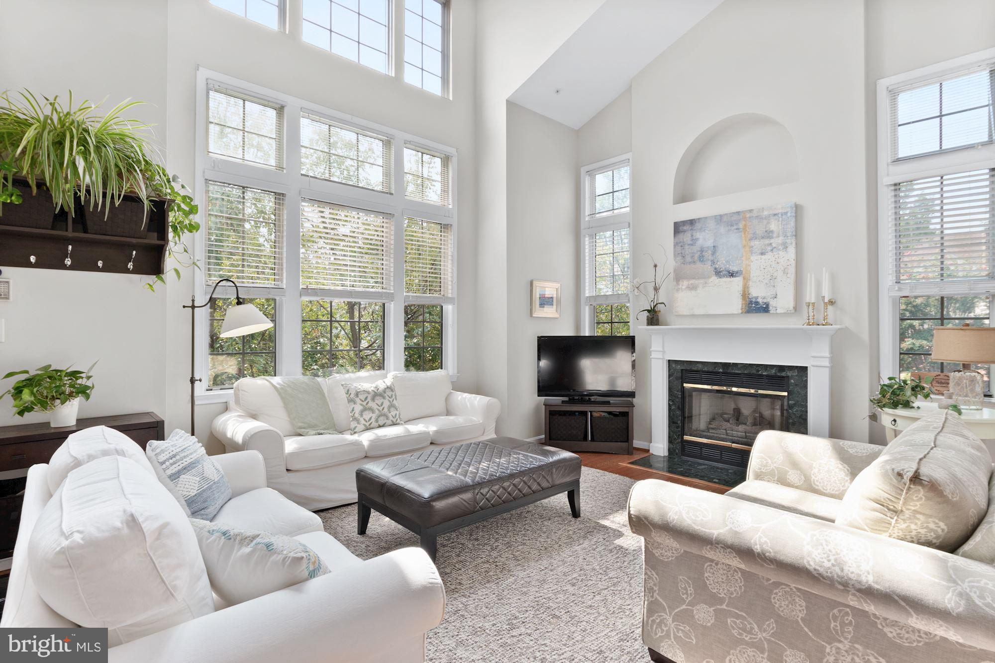 WHAT COULD BE BETTER THAN FINDING A STUNNING TWO-LEVEL 2,042 SF CONDO JUST ONE BLOCK FROM THE METRO WITH 2 CAR GARAGE PARKING,  PRICED AT ONLY  $685,000??......INCLUDING A SELLER INCENTIVE TO BUYER! Seller will provide a $5,388 credit towards Buyer's closing cost at settlement. This credit is equivalent to 6 months of condo fees.  DON'T MISS THIS  GREAT OPPORTUNITY TO OWN A SPECTACULAR CONDO! 
 
Rarely available 2 story END UNIT with 3 sides of windows and natural light and approximately 2042 SF according to tax records. Up the stairs to the landing and entrance to unit G 907 to the left. Last unit sold in April, 2021 at $693,500 was an Interior unit.  Dramatic and stunning,  light-filled 2 level condo with soaring vaulted ceilings.  2 Bedrooms, 2.5  Baths and Loft with 2 Car Garage Parking and Large Terrace off the Family Room. This End-Unit Condo is in the convenient, sought after neighborhood of Gates at West Falls right across the street from the West Falls Church Metro. Hardwood floors, cathedral two story windows, custom lighting and open living spaces are all anchored by an updated cook's kitchen with granite counters, recessed lighting and stainless steel appliances. The kitchen opens to a gracious family room with a sliding glass door that opens to a spacious walled patio for outdoor enjoyment and entertaining. The Living Room features a fireplace and is surrounded by the two story windows on two sides. The Dining Room is adjacent to and open to the Living area and generous in size. The Primary Bedroom Suite boasts a walk-in closet and an updated bathroom with dual granite vanity, walk-in shower and a soaking tub. Upstairs find a second bedroom and an updated bathroom with granite vanity and loft/office that overlooks the Living/Dining Rooms and has a custom Murphy wall bed and storage cabinetry. All this with ample extra storage space, secure garage parking for two cars and a phenomenal commuter-friendly location. Just one block to groceries, restaurants and shopping and with easy access to I-66 and the Metro.