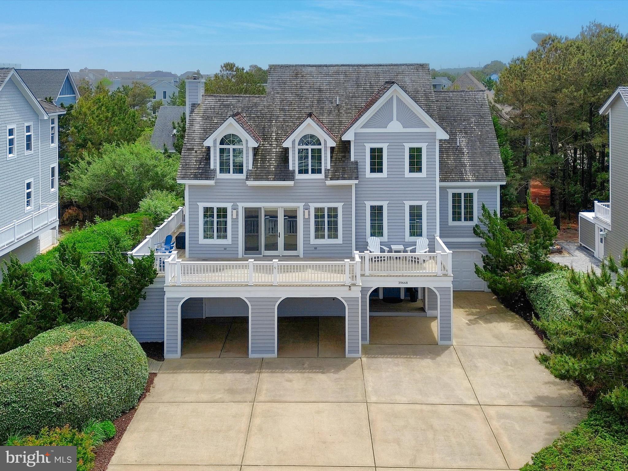 Coastal Luxury in The Preserve, North Bethany Beach  - Get ready to experience the ultimate in beachside living! Nestled in the highly sought-after gated community of The Preserve, this stunning 5-bedroom, 5 full bath, 2 half bath single-family home offers the perfect blend of luxury, comfort, and coastal charm — with private, guarded beach access, a community pool, and tennis courts just steps away. From the moment you arrive, the home's impressive curb appeal, expansive parking for up to 10 vehicles, and welcoming front porch with ocean views set the tone for everything this property has to offer. Inside, an open-concept layout flows seamlessly through a spacious living and dining area into a recently renovated kitchen, making entertaining effortless. Enjoy breathtaking ocean breezes from the large deck or unwind year-round in the expansive three-season room — perfect for relaxing after a day at the beach. The main level offers the primary bedroom, a serene retreat under the expanse of a cathedral ceiling, appointed with a dual ensuite with shared walk- in shower, and a spacious walk-in closet. Completing this level is a bonus room with a laundry center. The sleeping quarters on the upper-level host 4 additional guest bedrooms, each uniquely appointed, and all with private ensuite baths. Thoughtfully designed for both everyday living and hosting guests, this home comes fully furnished and move-in ready, allowing you to start making memories from day one. Don’t miss your opportunity to own a true North Bethany gem!