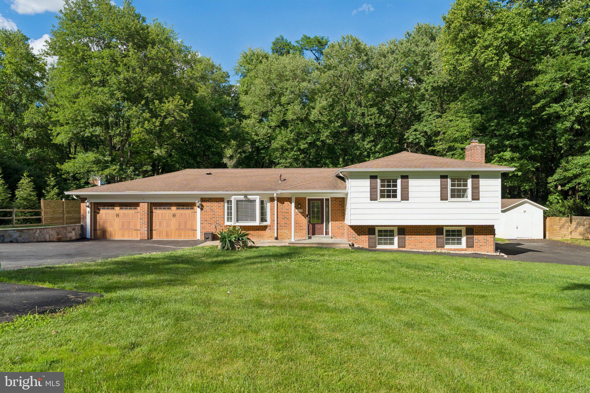 Nestled on nearly half an acre in Oakton's desirable Fox Vale community, this exceptional residence offers nearly 3,000 square feet of thoughtfully designed living space, surrounded by the natural beauty and privacy of county parkland bordering both the side and rear of the property.

Deceptively expansive from the street, this four-level home unfolds into an impressive interior featuring 4 bedrooms, 4.5 bathrooms, and an abundance of flexible living spaces designed to accommodate today's modern lifestyle. Rich wood and laminate flooring flows throughout the home, creating a seamless and sophisticated aesthetic.

The home's extensive list of recent improvements provides both luxury and peace of mind. All bathrooms have been beautifully remodeled within the last two years, including a stunning primary suite bath featuring a zero-entry walk-in shower. Major system upgrades include replacement windows (2022), septic distribution boxes (2023), a complete electrical panel replacement (2024), and installation of an electric vehicle charging outlet in the attached two-car garage. The septic system was professionally pumped in 2025, while the HVAC, plumbing, and electrical systems have been routinely serviced and maintained annually by licensed professionals.

Designed for both entertaining and everyday living, the finished lower level offers a versatile bonus room, wet bar, generous storage space, and convenient walk-up access to the exterior. Two separate laundry areas provide additional flexibility for multi-generational living, guests, or busy households.

Outdoor living is equally inviting with a charming backyard patio overlooking the private setting. A newly constructed storage shed adds valuable functionality, while the home's remarkable parking capacity sets it apart from anything else in the area. In addition to the attached two-car garage, dual driveways can comfortably accommodate approximately 20 vehicles, making this property ideal for entertaining, car enthusiasts, or households with multiple drivers.

Combining privacy, extensive capital improvements, versatile living spaces, and a coveted Oakton location surrounded by luxury homes, this is a rare opportunity to own a meticulously maintained property that offers both immediate enjoyment and long-term value.