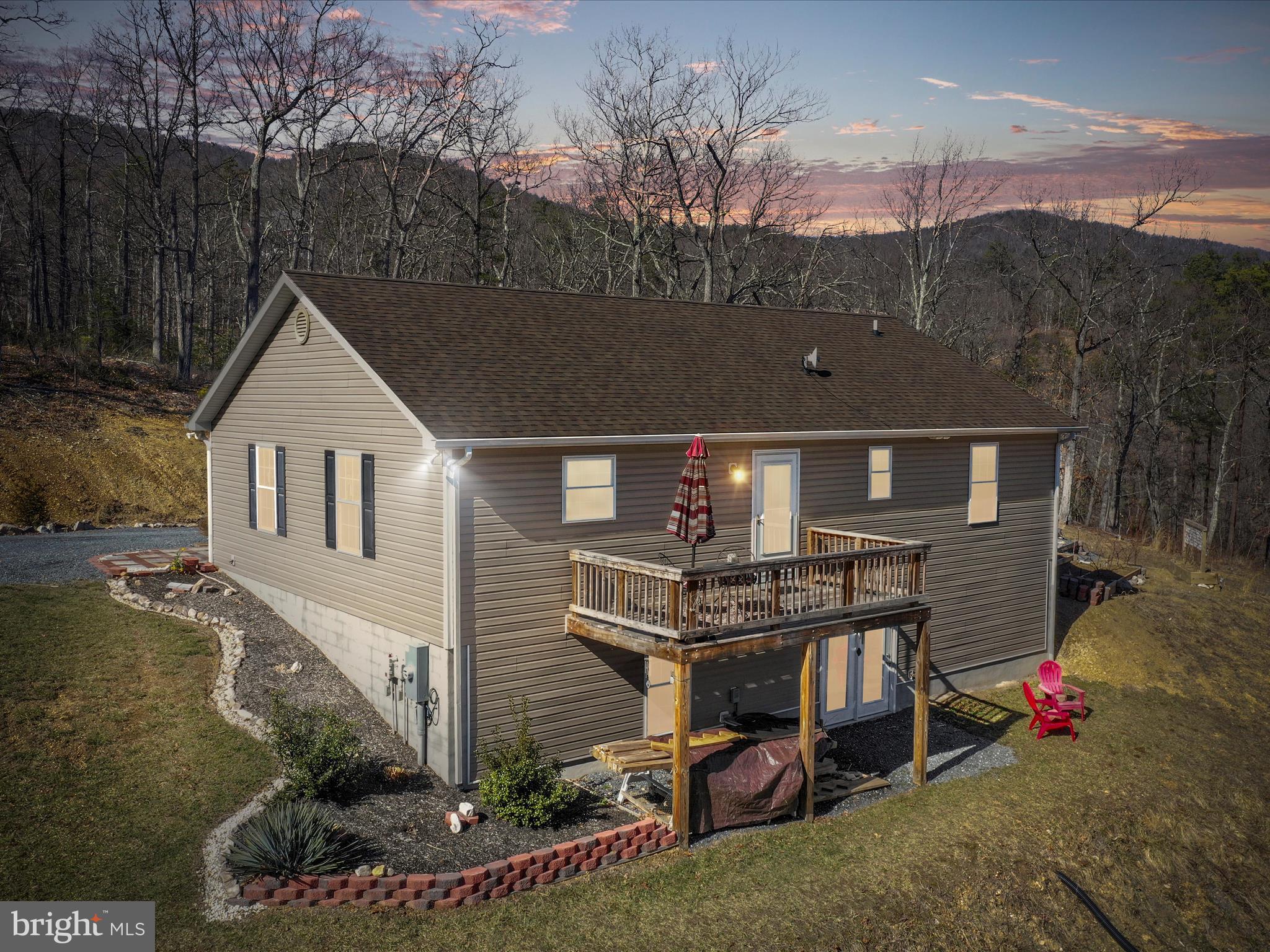 Welcome to your mountain getaway.   This charming ranch-style residence, built in 2019, offers a perfect blend of comfort and serene living. Nestled on nearly 3 acres, with an adjoining 11 acre Conservation Area  this  home boasts an inviting open floor plan that seamlessly connects the living spaces, making it ideal for both relaxation and entertaining. Step inside to discover three  bedrooms and two full bathrooms, thoughtfully designed for convenience and privacy. The main floor laundry adds to the ease of living, while the well-appointed kitchen features stainless steel appliances, including an electric oven/range, microwave, refrigerator, and dishwasher, ensuring meal prep is a breeze. Natural light floods the home, highlighting the beautiful laminated flooring throughout. Enjoy cozy evenings in your living area, or step outside to your porch or deck to take in the breathtaking Mountain Views and the tranquility of the surrounding trees and woods. The walkout basement offers additional potential for customization, whether you envision a recreation room, home office, or extra storage. With ample parking available in the driveway,  and oversized double garage this property is perfect for those who appreciate space and privacy. Experience the joy of country living while still being close to conveniences of the country store, fire house, post office and library.   Nearby Bryce Ski Resort, ATV trails, hiking vistas, Luray Caverns and canoe adventures on the Shenandoah River await.  Don’t miss the opportunity to make this warm and inviting home your own—schedule a showing today and start envisioning your new lifestyle!   Professional photos to follow.