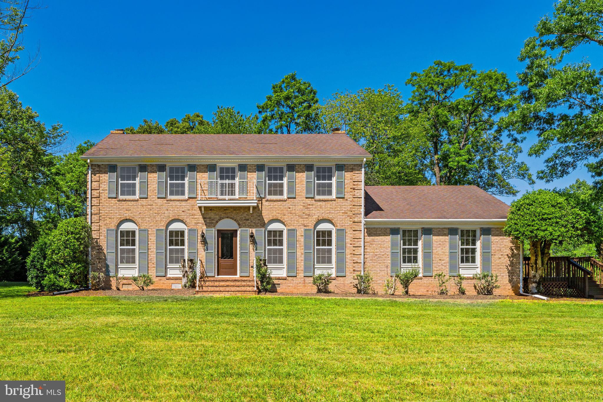 Welcome to this fully renovated all-brick colonial, nestled on a picturesque 2.65-acre setting in Greene County. Combining timeless charm with modern updates, this spacious home offers quality craftsmanship and a great location convenient to Ruckersville, Orange, northern Charlottesville, and historic Montpelier.  Inside, you'll find gleaming hardwood floors throughout both levels, all recently refinished.  The entire interior and exterior have been freshly painted. The main level features a formal living room, dining room, half bathroom, inviting family room with a wood-burning fireplace & built-in's, and an eat-in kitchen with pantry, laundry closet, stainless appliances, granite counters, and tiled backsplash.  There is a large additional room off of the kitchen that could serve as a second living area, home office, playroom, or a main-level primary bedroom, having a full en suite bathroom and walk-in closet.  There is also a renovated utility/mud room with built-in bench & shelving, and a door to the back yard.  All of the bathrooms in the home have been completely remodeled with new flooring, vanities, toilets, faucets, lighting, and tiled showers and tub surrounds.  Upstairs, the spacious primary suite offers an en-suite bath with a double vanity and walk-in closet, while three additional bedrooms provide plenty of space for family and guests, including one bedroom with custom built-in shelving.  Additional improvements include a new front door, new ceiling fans with remote controls, and repairs/repainting of the side deck. The crawlspace has been professionally remediated, encapsulated, and insulated by Weatherseal, and the chimney has been professionally cleaned and inspected, and a new damper installed.  The outside includes a side deck, rear brick patio, mature landscaping, and two storage sheds.  This exceptional property offers the perfect blend of classic Colonial architecture, modern updates, and peaceful country living, all within easy reach of shopping, dining, wineries, and commuting routes.  Don't miss your opportunity to be the next owner of this beautiful property!