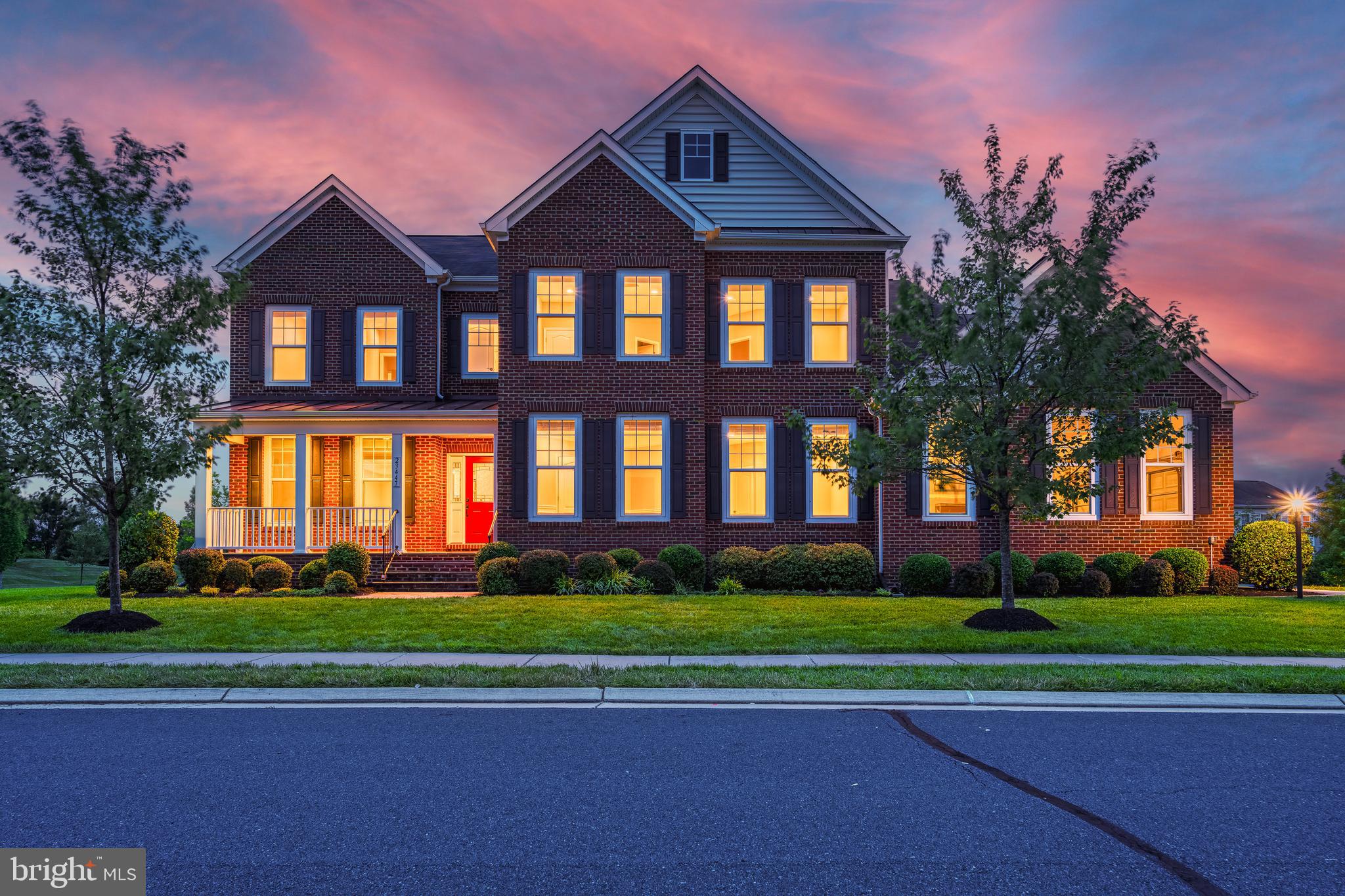 This exquisite colonial-style home features a total of seven bedrooms and six full baths with nearly 7,000 square feet of finished living space and a thoughtfully designed floor plan. Situated on a nearly half-acre corner lot, this home provides privacy and tranquility while remaining close to all the amenities of this sought-after community.   Upon entering, you're greeted by a grand foyer leading to an open and airy layout, highlighted by a beautiful winding staircase. Gleaming upgraded Acacia hardwood floors seamlessly connect each room. The incredible gourmet kitchen is a chef’s delight, with new sleek quartz countertops, high-end stainless steel appliances, an expanded center island with built-in storage, and abundant upgraded cabinetry. The sunroom, with east and south exposure, fills the space with natural light.

The spacious family room, warmed by a cozy fireplace, offers a place for rest and relaxation and flows seamlessly into the formal living and dining rooms, making it perfect for entertaining guests. For added convenience, the main level includes an in-law suite with a full bathroom, ideal for accommodating guests or family members. The home office, situated at the front of the house, provides a quiet and private space perfect for working from home.

Ascending to the upper level, you will find the luxurious primary suite, which features a large sitting room, dual walk-in closets, and a lavish bathroom complete with dual granite top vanities, a soaking tub, and an oversized frameless glass shower. The four additional bedrooms on this level are generously sized, offer ample closet space and ceiling fans for added comfort.  Two of the bedrooms share a jack and jill bathroom with upgraded granite vanities and tile flooring, and the others feature an equally upgraded private ensuite.  The laundry room is conveniently located on the bedroom level.  The HVAC on the upper level was recently replaced, enhancing this homes energy efficiency and providing hassle-free living for years to come!

The fully finished basement is an entertainer’s dream. With direct access to the backyard and deck, hosting gatherings is a breeze. This space features a recreation room with a second gas fireplace, a media room, a custom wet bar with a full size refrigerator and dishwasher, a bedroom, a full bathroom, a gym room, and ample storage. The recreation room's fireplace adds a cozy ambiance, making it an inviting place to relax and enjoy.

Nestled on a beautiful corner lot with no neighbor on one side, this home offers privacy and tranquility. The custom deck and south-facing backyard is bathed in sunlight, making it perfect for outdoor activities and relaxation. The property also includes a three-car side garage and a charming front covered porch.

Residents of Brambleton enjoy numerous community amenities such as a pool, tennis courts, pickleball, basketball courts, trash services, cable, and high-speed internet included in the monthly HOA dues. The home is within walking distance to Hall and Berni Park, which features  a splash pad, tennis and pickleball courts, disc-golf, cricket, football, soccer fields, and wooded trails. Additionally, the Brambleton Town Center is just a short walk away, offering a variety of shopping, dining, and entertainment options.