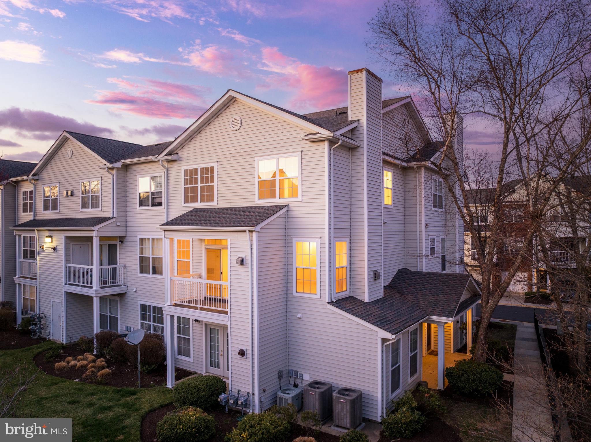 Welcome to 13057 Marcey Creek Road, a beautifully maintained end-unit, townhome-style 3-level condo with a 1-car garage, perfectly positioned in one of Herndon’s most walkable and connected communities. This home truly has it all—location, layout, and lifestyle. Just blocks from the Herndon Silver Line Metro station, the newer elementary school, and the Clocktower Shopping Center, plus only 300 yards from Harris Teeter across a charming waterway, and seven blocks to the W&OD Trail. Inside, the spacious open floor plan is flooded with natural light and offers fresh paint throughout, picture-framed windows and doors, and laminated flooring across all levels. The main level is perfect for entertaining with a cozy gas fireplace, and an upgraded kitchen featuring granite countertops, stainless steel appliances, and new fixtures. Step out onto your private balcony that overlooks a tranquil picnic area and mature trees—an ideal spot to enjoy morning coffee or unwind at sunset. Upstairs, you'll find two generously sized bedrooms with vaulted ceilings, large walk-in closets, and two full updated bathrooms.  The entry level includes a front-facing garage with additional driveway parking and a separate front door entrance on the side for added convenience. Enjoy access to top-tier community amenities including a swimming pool, fitness center, clubhouse, trails, community grill and picnic areas, and playgrounds around the corner. With easy access to Dulles Airport, Reston Town Center, major commuter routes like Route 28, Fairfax County Parkway, I-66, and the Dulles Toll Road, this home offers unbeatable value in a rapidly growing transit-oriented location.