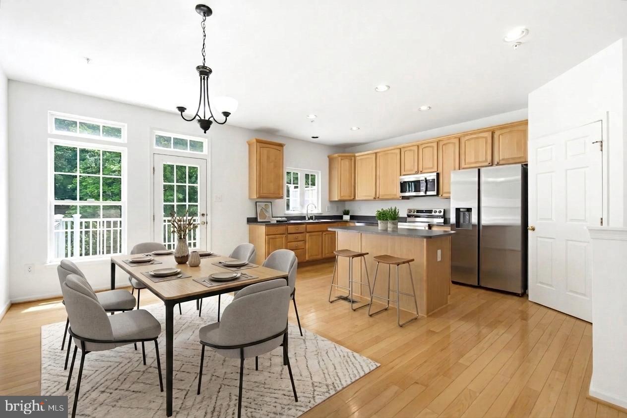 Welcome to this lovely move-in ready townhome in the popular Honeygo Village community! This home offers 2 primary Suites 3.5 Bathroom and 2 Car Garage. From the moment you walk in, you'll appreciate the flexible first-floor space with glass doors and a full bathroom—perfect for a home office, guest room, workout area, or whatever fits your lifestyle.  The main level offers hardwood floors, a comfortable family room, and a convenient powder room. The kitchen opens to a rear deck with a peaceful green view, making it a great spot to enjoy your morning coffee or unwind at the end of the day.  Upstairs, you'll find two spacious primary suites, each with its own private en suite, providing comfort and privacy for everyone. Whether you're hosting friends for the holidays, enjoying a quiet evening on the deck, or simply settling into your new neighborhood, this is a place that feels like home from day one. 
RECENT UPDATES : All Kitchen appliances (2026),  Washer & Dryer (2026), Fresh interior paint (2026), New Carpet (2026),  Hot water heater (2024)