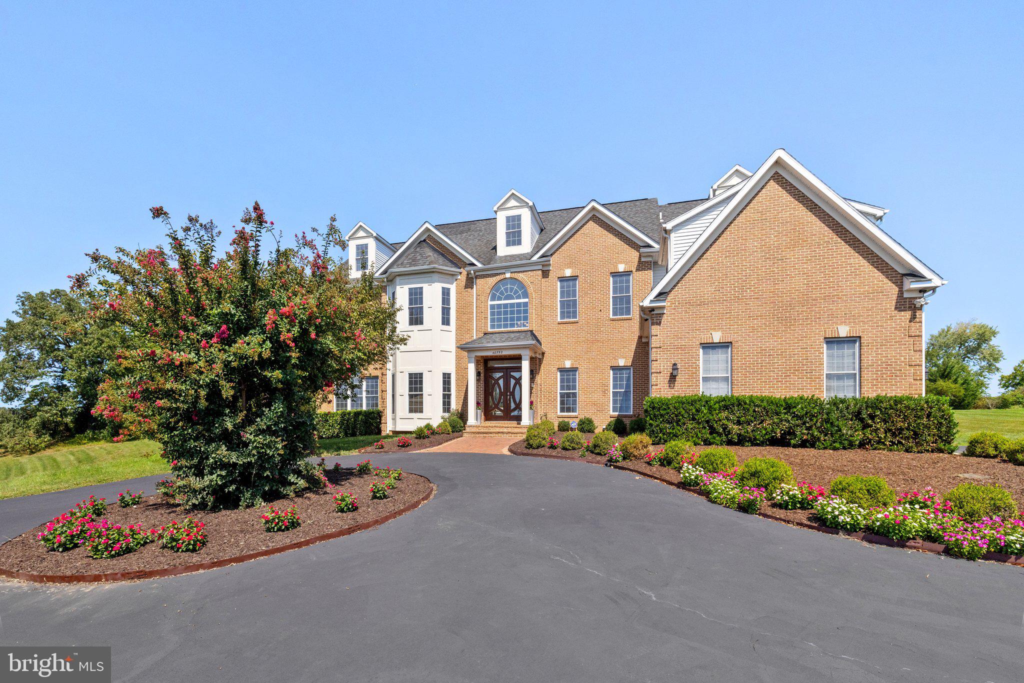 Welcome to one of Loudoun County's most luxurious and sought-after neighborhoods, Shenstone Farm! This beautiful home sits on a gorgeous elevated 4+ acre lot at the top of the hill and has so much to offer. With almost 6100 square feet of living space ABOVE GROUND and over 8700 total, this property is extremely spacious with 4 bedrooms, 4.5 bathrooms, a bonus 4th level loft, and a massive unfinished basement just waiting to be personalized! The main level boasts a grand foyer that greets you as soon as you walk in. You'll find a very spacious sunroom where you can relax, or use this as a recreation space! This level is also home to a lovely formal dining room, sitting room, and main living room that flows into a gorgeous dark eat-in kitchen! You'll enjoy all new stainless steel kitchen appliances and so much countertop space, and bask in the natural light of the bonus dining space. Heading upstairs you'll find 4 very large bedrooms each with their own en-suite bathroom - no need for sharing in this house! Each bedroom also offer beautiful views from the hilltop, which is what Shenstone Farm is all about. The primary bedroom comes equipped with a wet bar and a private balcony, and a gigantic primary bathroom with a steam shower and oversized walk-in closet! Heading up to the loft, you'll have access to a large recreation space, and plenty of storage closets to boot. The basement is truly a blank canvas with just under 2700 square feet of unfinished space - design your dream basement without having to compromise from lack of space! Outside you'll enjoy the sprawling 4+ acre lot with tons of yard space, and the home comes equipped with a beautiful Trex deck as well. For the vehicles, you'll have a spacious 3 car garage with high ceilings perfect for adding storage racks! The icing on the cake is the location as you're just a short drive to historic Downtown Leesburg, which offers so many options in the form of coffee shops, delicious restaurants, shopping, and more.  Battlefield Shopping Center is just a short trip away as well, and you'll have easy access to the toll road and major transportation routes. This home is truly the full package, so be sure to come see it for yourself!