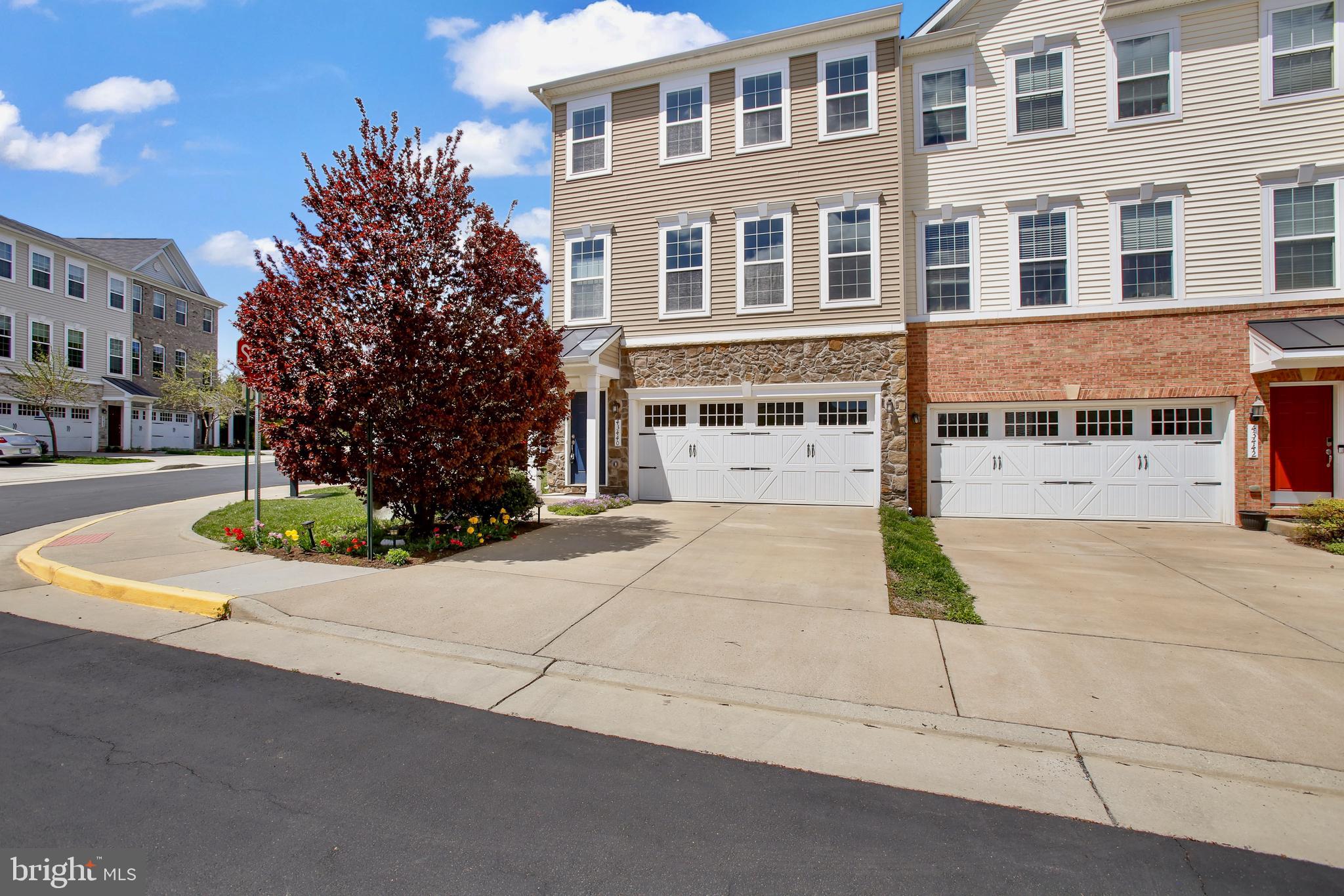 Welcome to your dream home the in the heart of Ashburn! This stunning 4-bedroom, 3.5-bathroom home built in 2016 is packed with high-end upgrades and located on a Premium Corner Lot! Offering modern elegance and exceptional comfort, this home combines luxury with the convenience of urban living. Step inside from the black Copper Roof Portico, to find pristine hardwood floors spanning the entire main level. The open floor plan is anchored by a chef’s dream kitchen, featuring custom cabinetry, top-of-the-line GE stainless steel appliances, 5 burner gas cooktop, granite countertops, an elegant Silgranit black deep farmhouse sink and an oversized island thoughtfully illuminated with pendant lighting —perfect for entertaining. A large walk-in pantry and space for a generous dining table complete this thoughtfully designed space. The adjacent family room is equally impressive, with gorgeous built-in custom cabinetry inspired by a well known Architect! A Top of the Line built-in surround sound projector system to enjoy, an entertainer's dream! Just outside, an expansive Trex deck, backing to trees, offers privacy and invites you to relax with your morning coffee or unwind in the evening, or retreat to the paver patio and relax surrounded by lush gardens bursting with borders of phlox, the cherry tree and springtime tulips. Upstairs, the luxurious primary suite with a tray ceiling and a spa-like bathroom is so inviting, with a dual vanity and featuring a huge seamless glass Roman shower, private water closet and an oversized walk-in closet.  Two additional spacious bedrooms are conveniently located down the hall. A large walk-in laundry room with custom cabinets and the second bathroom complete the upper level. The lower walk-out level offers a spacious recreation room or fourth bedroom with large windows that flood the space with natural light. You'll also find a separate walk-in Butler's Pantry complete with a fridge and 2nd microwave. A luxurious full bathroom completes this space, including a large storage room for all your organizational needs. A rare find in sought after Ashburn, this home seamlessly blends modern amenities with the convenience of urban living—all just steps from fantastic shopping, dining, and entertainment.