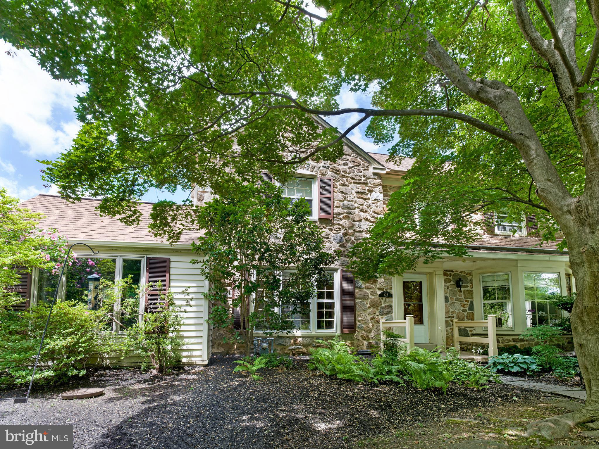 Located in the coveted Shortridge Tract of Wynnewood, this classic stone Colonial is surrounded by mature specimen trees, lush gardens, and a charming covered front porch, creating a private and picturesque setting on a beautifully landscaped .19-acre lot. Offering 3 bedrooms, 2 full baths, a powder room, central air, gas heat, an attached two-car garage, and a partially finished basement, the home blends timeless character with thoughtful updates. 

A welcoming center hall foyer introduces gracious, light-filled rooms with hardwood floors throughout much of the first floor. The spacious living room features a fireplace, custom built-ins, and large windows overlooking the gardens. Just beyond, a sun room with a stone accent wall provides the perfect space for relaxation.  The walls of windows overlooking the gardens offers a peaceful place to enjoy the changing seasons.

The formal dining room, highlighted by a beautiful bay window, provides an elegant setting for entertaining and everyday meals. The updated kitchen features granite countertops, stainless steel appliances, abundant cabinetry, and convenient access to the rear yard. A powder room completes the first floor.

The second level offers a spacious primary suite with a private bath, while two additional generously sized bedrooms share a hall bath. A large walk-up attic provides exceptional storage and potential for future expansion.

The partially finished lower level offers flexible space for a recreation room, exercise area, or playroom, while the unfinished area provides abundant storage.

Ideally located within the award-winning Lower Merion School District, this exceptional home is just moments from Shortridge Memorial Park, Wynnewood Valley Park, Suburban Square, regional rail service, and Center City Philadelphia. A rare opportunity to own a beautifully maintained stone Colonial in one of Wynnewood’s most desirable neighborhoods.