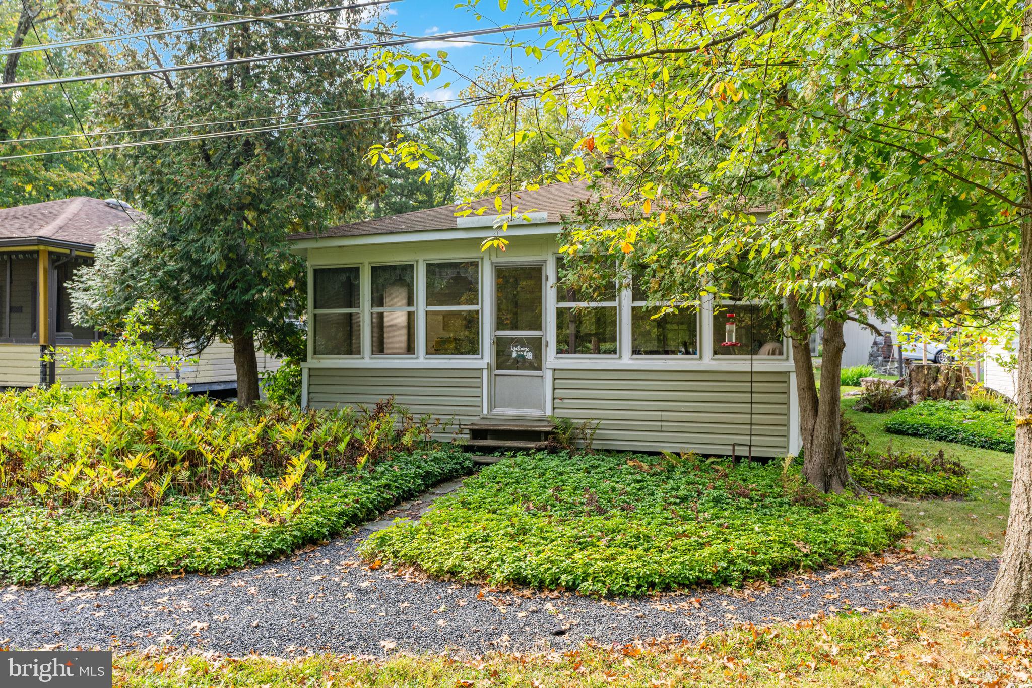 If you’re looking for a simple summer place, this is it. A 2-bedroom, 1-bath seasonal cottage in Camp Oaks, tucked into a mature, wooded setting and set up for low-maintenance use during the warmer months. Inside, the layout is simple: a cozy kitchen, a good-sized living room with a propane stove for heat, two bedrooms, and a sunroom lined with windows overlooking Unami Creek. Outside, enjoy access to a shared dock, relax by the water or go kayaking in the creek. Water is shut off by the association from November through April, and full-time living is not permitted. The $1,300 annual fee covers taxes, water, trash, and common ground liability insurance. Schedule your private tour today.
