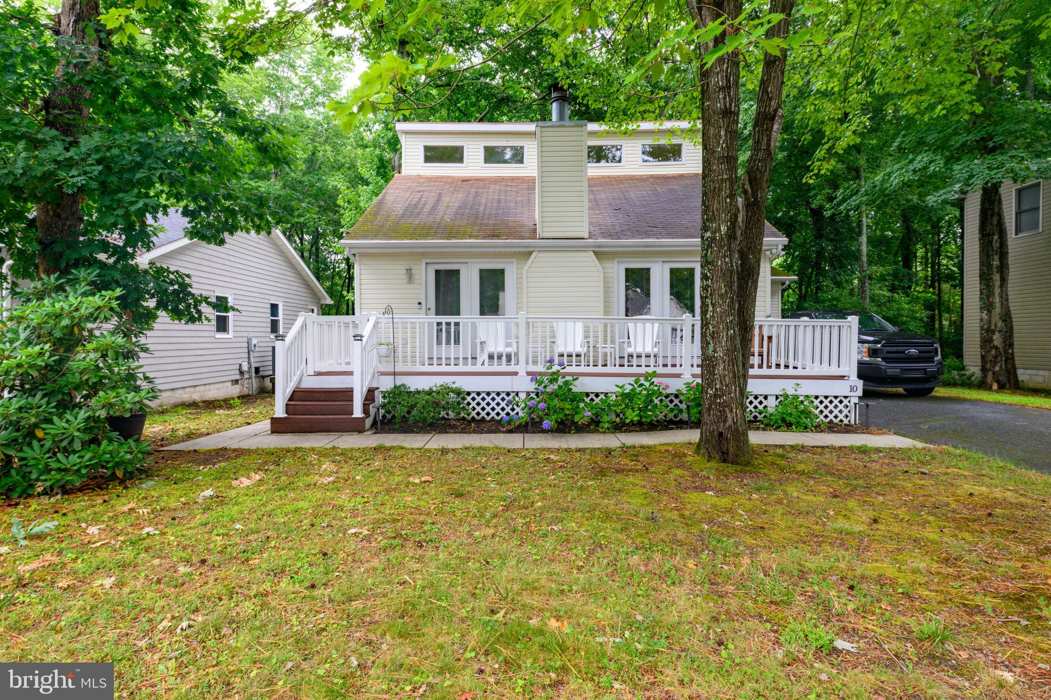 Welcome to this well-maintained home in the desirable Nantucket section of Ocean Pines, offering the perfect blend of comfort, functionality, and low-maintenance living. Situated on a nicely wooded lot with just the right amount of privacy, the yard is easy to maintain while still offering plenty of opportunity for gardening or additional landscaping. Enjoy relaxing on the inviting front porch or unwind in the fenced backyard featuring a fire pit and seating area, perfect for entertaining or quiet evenings at home. Inside, this gently used second home has been meticulously cared for. The flexible floor plan includes a main-level bedroom and full bathroom, making it ideal for guests or first-floor living. The combined living and dining area is anchored by a cozy wood-burning fireplace, while engineered hardwood flooring runs throughout the home with beautifully stained oak stairs adding warmth and character. The kitchen offers abundant Thomasville cabinetry, generous storage, and a practical layout designed for everyday living. Just off the Kitchen area, you will find the spacious four-season room provides endless possibilities as a home office, TV room, reading nook, hobby space, or additional gathering area.
Additional features include:
• HVAC replaced in 2020
• Nest smart thermostat
• Main-level laundry
• One-car garage with built-in storage and dehumidifier
• Crawlspace dehumidifier
• Updated shower fixtures
• Freshly painted upstairs bathroom with a modern LED vanity mirror featuring adjustable brightness and color temperature
Whether you're looking for a full-time residence, weekend getaway, or beach retreat, this home offers comfort, thoughtful updates, and the Ocean Pines lifestyle just minutes from Ocean City beaches, dining, golf, marinas, and shopping.