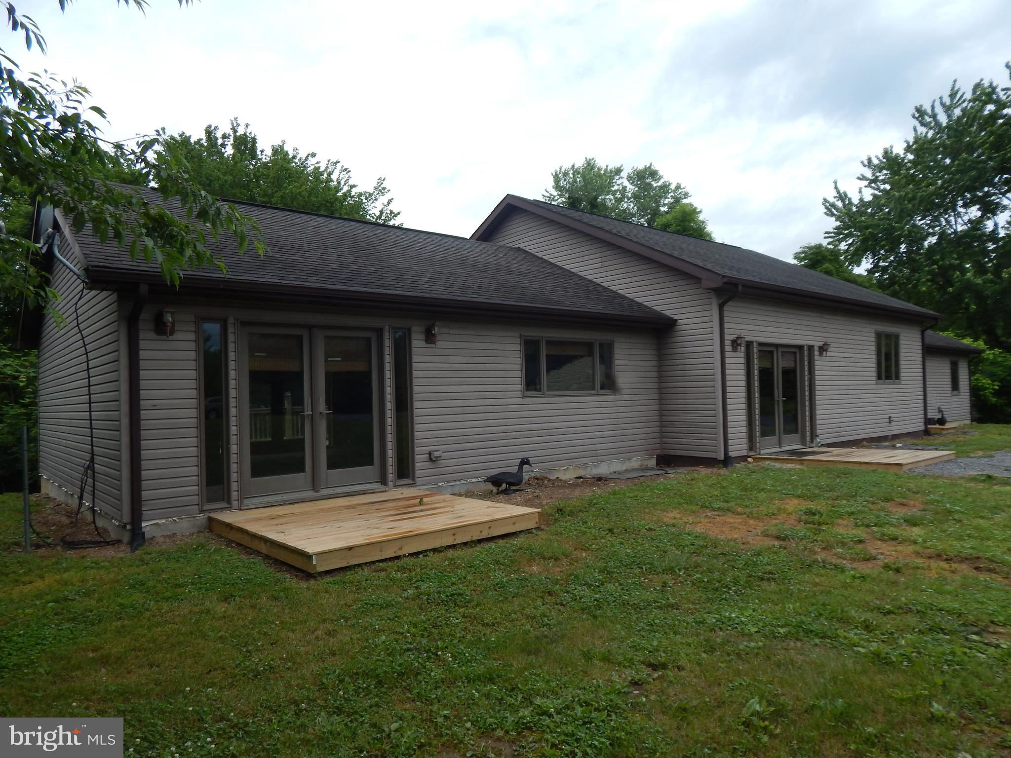 TWO HOUSES FOR THE PRICE OF ONE!!   Priced for a quick sale!   2BR/2B 2236 sq. ft. home built in 2006 on .538 acres.    Main Section is an open Living Room/Dining Room/Kitchen.  One wing is the owners suite with spacious bedroom area plus sitting room area.  Adjoining Bath is large with Jaccuzzi tub, shower.   Bedroom and Bath has tile with radiant heat.   Second wing has a Bedroom, Bath with Laundry and a sitting room, all with radiant heat. Large rear deck.   Detached 1 car garage on one half and workshop on the other side.   Additional 621 sq. ft. home built 1948.  Used as a rental. All three structures are on separate parcels.  Garage had new roof and siding in 2020 and Rental had a new roof in 2020.   In addition to the heat pump in the newer home,  an outdoor wood burning stove heats the newer home plus the rental home.