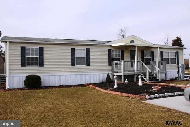 Commodore Double Wide with 1568 sq. ft. Cathedral Living Room w/gas stone fireplace, wooden beams. Eat-in Kitchen with breakfast bar, laundry area, tons of counter space, 2 full baths, owner's bedroom with two closets adjacent to a luxurious spacious bath, separate shower. Private, backs up to open land.