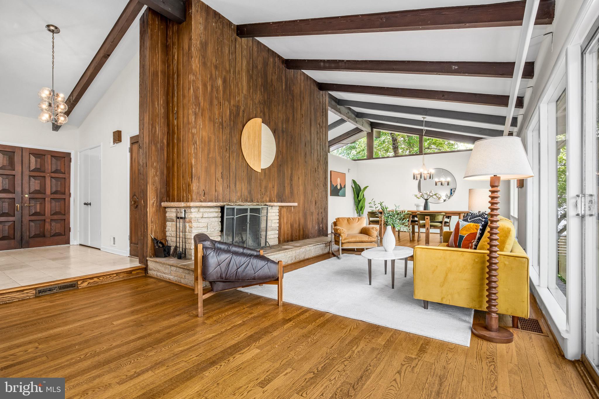 Some homes are built to sell. This one was built to last a lifetime — and it has.

Designed and built in 1958 by acclaimed mechanical engineer Fredrick G. Williams as his own personal residence, 9115 Levelle Drive is a testament to a level of intentional, uncompromising craftsmanship rarely seen today. Every proportion, sight line, and material choice reflects the vision of a man who knew exactly what he was doing — and who was building not for the market, but for his family. Now offered for only the second time in its history, this is a once-in-a-generation opportunity to steward a true original.

Set on nearly an acre (.89 acres) in one of Chevy Chase’s coveted enclaves and positioned at the end of a quiet dead-end street, the property unfolds with a sense of privacy and arrival. Mature trees and gardens — lovingly tended over decades — frame the home and yard,creating beauty across every season.

The architecture is quintessential mid-century modern: clean horizontal lines, an effortless connection between interior and exterior, and an atmosphere of calm, purposeful elegance. Expansive floor-to-ceiling windows flood the home with natural light and draw the landscape in, reinforcing the sense of openness and retreat. At the heart of it all, a monumental fireplace surrounded by Pecky Cyprus wood which commands the main living space — the kind of architectural anchor that draws people together and defines a room. It isn't a feature. It's the soul of the home.

With five bedrooms and three full bathrooms and over 3900 square feet, the layout is as generous as it is thoughtful. The main levels offer gracious, light-filled living, while the walk-out lower level opens up an entirely separate world of possibility: two generous bedrooms, a full bathroom, a sprawling family room, a dedicated office, and a laundry room — with room left over to imagine. Guest suite, au pair quarters, creative studio, or home gym — the lower level adapts to the life you want to live.

Outside, a swimming pool anchors the rear grounds, inviting long summer afternoons and effortless entertaining surrounded by the privacy of tall trees and mature plantings. A two-car carport and additional driveway provide ample, easy parking — practical notes to a property that has thought of everything.. Overlooking a green lawn rather than a street, the only passersby are on foot or bicycle.

To own 9115 Levelle Drive is to join a remarkably short line of custodians — just two families before you. The stories held within these walls, the care layered into these gardens, the integrity engineered into every beam: all of it passes to you.

Homes like this don't come back around. This one is ready for its next chapter.
