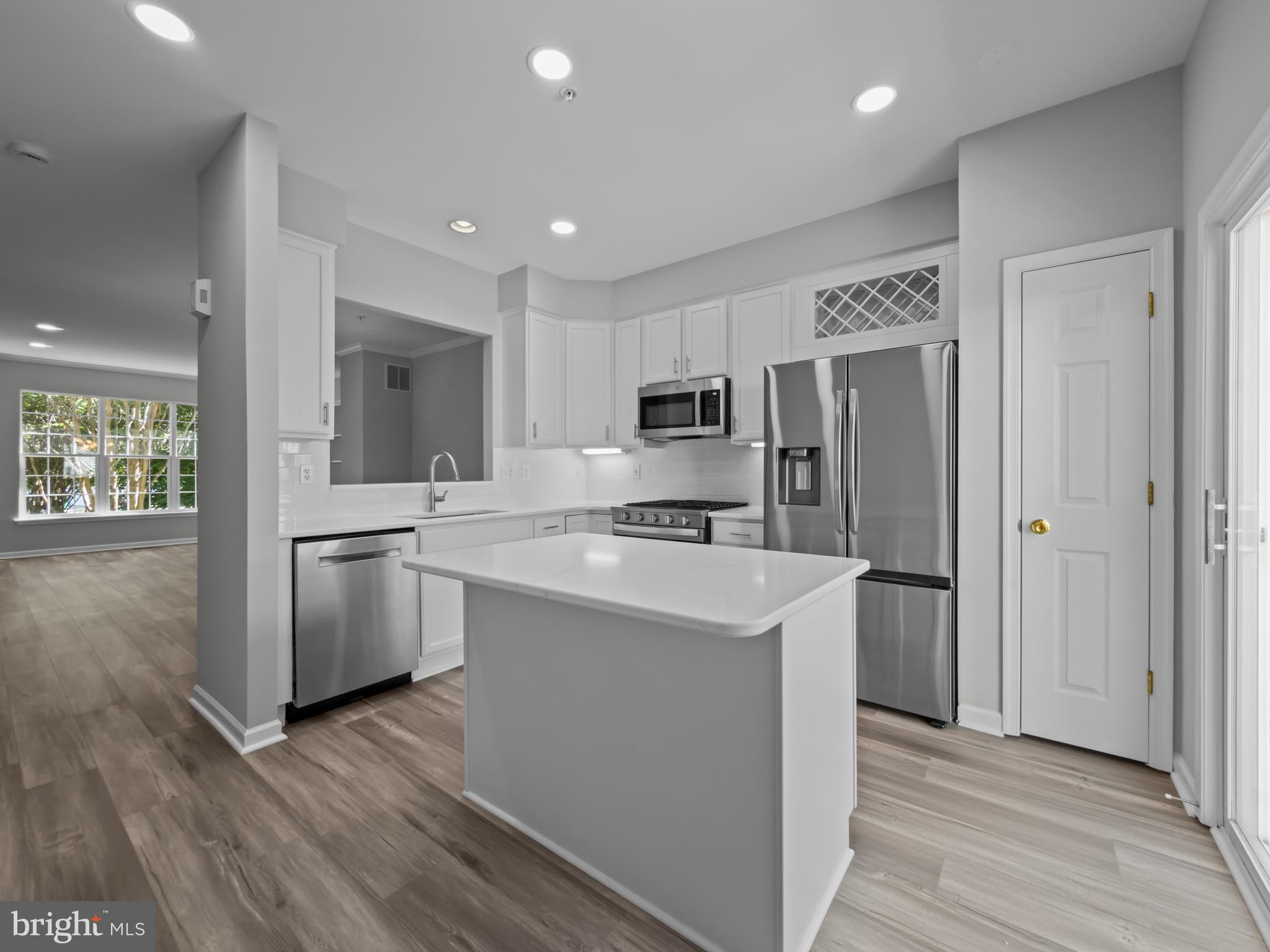 Welcome to this beautifully updated townhouse in sought after Washingtonian Center just minutes away from all of the great amenities Crown and Rio have to offer . The open living and dining area is bathed in natural light from front and rear exposures.
The renovated kitchen features white cabinetry, quartz countertops, and stainless steel appliances, flowing seamlessly onto a spacious deck, perfect for relaxing or entertaining. The entry-level sitting room offers flexible use as a home office or easily converted to a bedroom.
Enjoy peaceful views of trees and open green space from the front of the home. A rear-entry two-car garage and private driveway add everyday ease and convenience.
Fresh updates throughout include new LVP flooring, new Berber carpet on the lower level and upper level, and freshly painted interiors throughout. 
Ideally situated just minutes from the shops, restaurants, fitness centers, and lakefront entertainment of Crown and Rio including popular summer concerts by the lake with grocery stores, retail, and home improvement stores all close at hand.