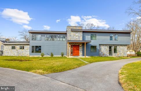 This home is truly amazing.  Inspired by Frank Lloyd Wright.  four panel folding glass door wall to the patio.  Amazing one of a kind pivoting wood front door. Screened house with kitchen and water and electricity.  Boat lift and slide on the pier.  The community also has a beach and playground with basketball court.  If you are interested in a high end waterfront, you owe it to yourselves to view this wonderful property.   8 feet plus water depth at the end of the pier.