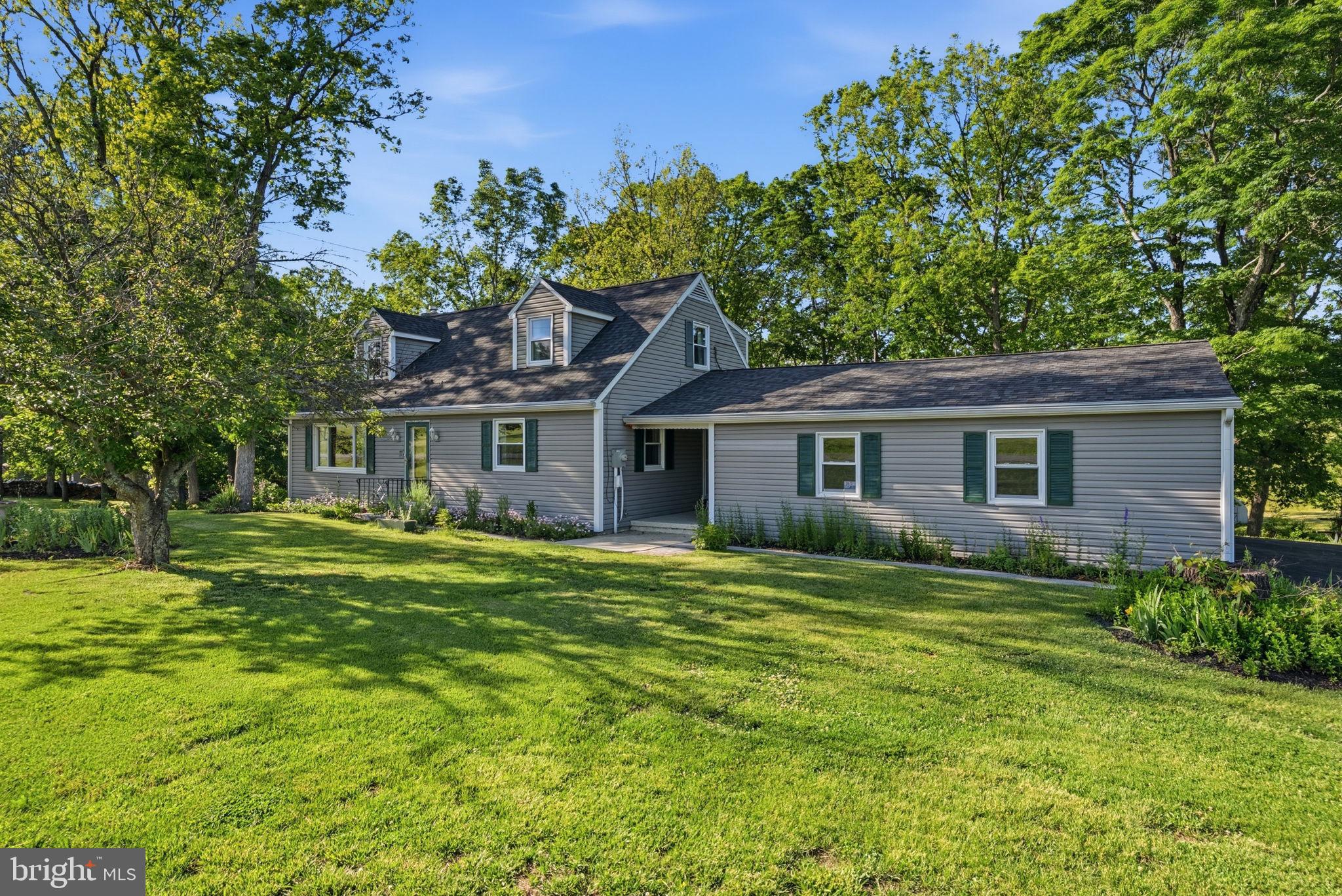 Rock Solid Cape Cod!  Lovingly maintained.  Newer roof, siding,  windows, kitchen counter tops and appliances.  Windows  have a lifetime warranty.  Beautiful county setting, with gently sloping back yard with a huge stone fireplace.  Across the small stream is a larger yard/field, totaling 2.20 acres of privacy. 
First floor bedroom and full bath, living room and dining room.  Upstairs has two LARGE bedrooms, full bath, closets and "cubbie" storage.  
The partially finished basement is cozy with a fireplace with gas insert ( just needs propane tank).  Extra amenities include a central vac system and an intercom system.
Home is move in ready!  Don't miss out on this one!!
