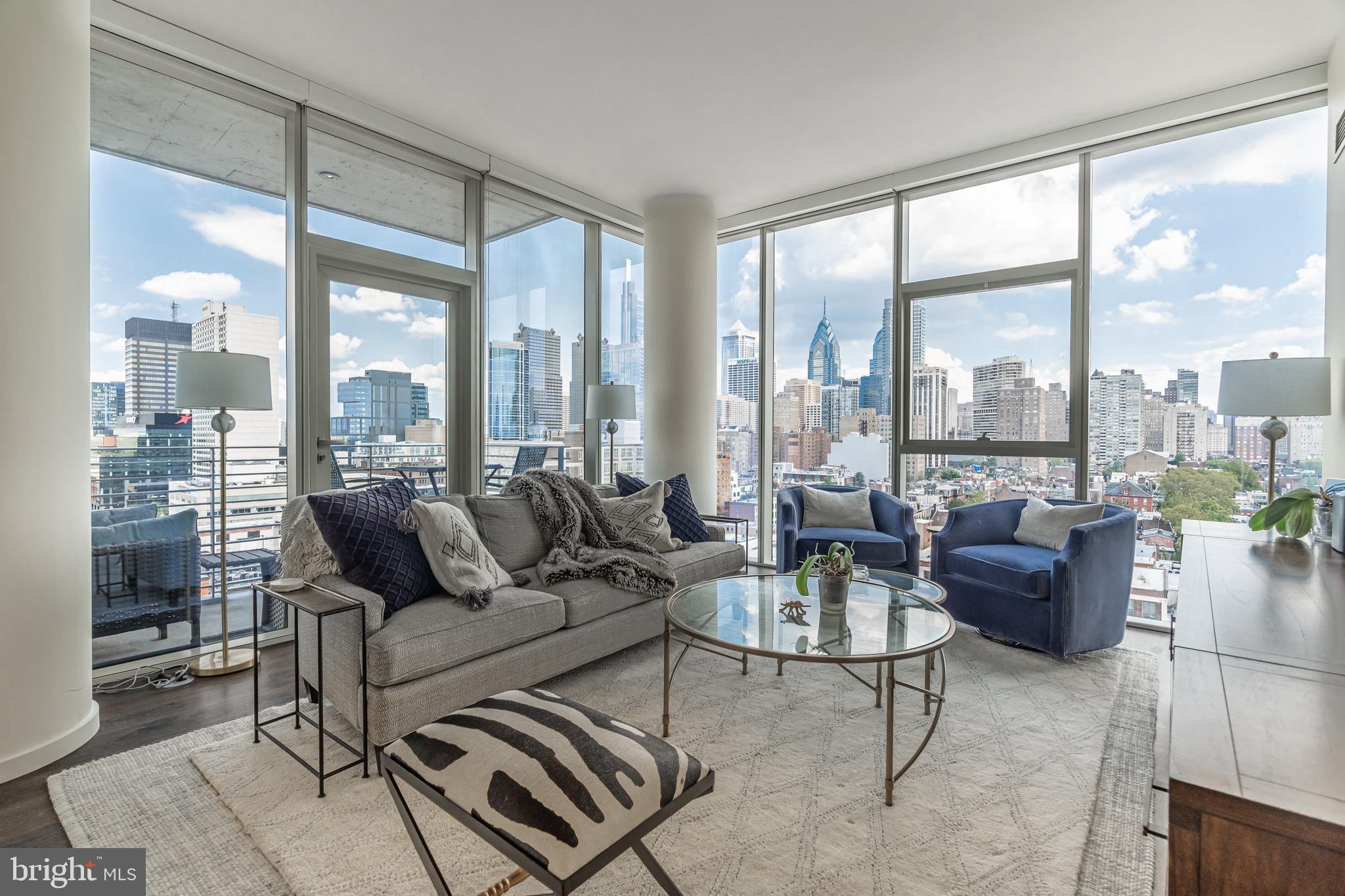 Welcome to ONE RIVERSIDE, Philadelphia’s ultimate luxury condo building in the heart of Fitler Square.   Unit 1403 spans 1227 sq ft and features 2bd, 2.5 baths, one parking spot, and is the highest floor the coveted 03 floorplan is offered.  Enjoy unobstructed panoramic views of the city, including the north river corridor, FMC Tower, the Art Museum, and the river trail. The unit also has around 5 years remaining on the tax abatement.

Walking through the doors to this sleek luxury condo, you enter through the foyer and into a bright and airy kitchen and living room area, with high ceilings, newly finished wood floors, and show-stopping views of the river and surrounding city life through the floor to ceiling windows. The gourmet kitchen is any chef’s dream, with Miele appliances, custom white cabinetry, and marble countertops for your guests to hang while you're entertaining.  There is also room for an additional seating area next to the island, where you can enjoy coffee and breakfast with an incredible view, or head outside to your private balcony for some fresh air.  Adjacent to the kitchen is the sun-filled living area, perfect for entertaining and everyday relaxation.

There is a powder room situated between the kitchen and living room with lovely accents. Next to the living room, you will find your first bedroom, complete with an ensuite bath. This bedroom offers impeccable views and is very spacious. The ensuite offers a stand-up shower and marble accents throughout and is perfect for guests or home office.

Back towards the entrance hall, you’ll find your primary bedroom with floor to ceiling windows and spa-like ensuite bathroom. Your bedroom is also outfitted with two large closets. Wake up every the morning to a flood of natural sunlight with a view of the river, and enjoy your en-suite bath, with oversized soaking tub, frameless glass shower, and double marble vanity with custom cabinetry and storage.

This residence also includes a laundry closet with a full-sized washer and dryer. 

Built by premier developer Carl Dranoff and designed by acclaimed architect Cecil Baker, One Riverside is located in charming historic Fitler Square. One Riverside is within easy walking distance of Rittenhouse Square, the University of Pennsylvania, Drexel University, 30th Street Station, CHOP and the just named BEST URBAN TRAIL IN THE NATION. One Riverside also offers full service concierge and door staff, chauffeur driven town car, state-of-the-art fitness center with locker rooms, saunas, steam rooms and showers, 60' indoor lap pool, club room with a catering kitchen, board room, hospitality suite, bicycle storage, private pocket park, and an outdoor terrace equipped with BBQ grill and television. Parking license for one car included in list price. Don’t wait to take advantage of the ultimate living experience near the river, the park, the trail, and the city.