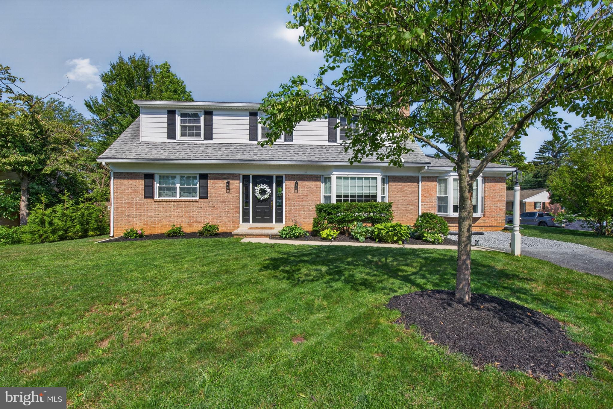 Renovated 5-bedroom, 2-bath brick Cape Cod in the heart of Manheim Township offering over 2,500 square feet of living space. New luxury vinyl plank flooring extends throughout the entire main level, where you'll find a spacious living room featuring a classic wood-burning brick fireplace and a large bay window that fills the space with natural light. The completely renovated kitchen showcases quartz countertops, a herringbone tile backsplash, a flush-mount sink, stainless steel appliances, and a cozy breakfast nook. Just beyond, the expansive dining room with a vaulted ceiling and skylight provides the perfect setting for everyday meals or entertaining guests. Two bedrooms and a beautifully renovated full bath with tile flooring and a walk-in tiled shower complete the main level. Upstairs offers three additional spacious bedrooms, a walk-in cedar closet, and a second newly renovated full bath featuring tile flooring and a tiled tub/shower surround. The newly refinished basement provides valuable additional living space, highlighted by a second brick fireplace and rough-in plumbing for a future wet bar, ideal for a rec room or entertainment area. Relax outdoors on the screened rear porch overlooking the backyard. The newer detached garage includes electric service and a storage loft, while two separate driveways provide plenty of off-street parking. Ideally located just minutes from major shopping, restaurants, parks, and everyday conveniences. Schedule your private showing today!