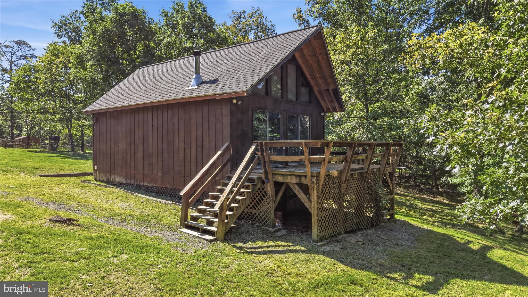 Escape to the mountains with this charming 2-bedroom, 1-bath home on over 3 acres with breathtaking views. Whether you're looking for a full-time residence, weekend getaway, or short-term rental opportunity, this property offers the perfect blend of comfort and outdoor living.
Enjoy stunning sunsets and mountain views from the deck, relax by the cozy wood stove, and embrace the peace and quiet that make this property the perfect escape from the hustle and bustle of everyday life. Step inside and you'll be greeted by lots of natural light, fresh paint throughout, and an updated kitchen featuring new cabinets and countertops.
A detached garage provides additional storage, workshop space, or room for recreational equipment. Recent improvements include a new roof and electrical updates in 2018, plumbing updates in 2023, and a new water filtration system installed in 2026.
Conveniently located just 10 minutes from Cacapon State Park and only 30 minutes from Winchester, VA, you'll enjoy easy access to hiking, golf, fishing, dining, and everyday amenities while still feeling miles away from it all.