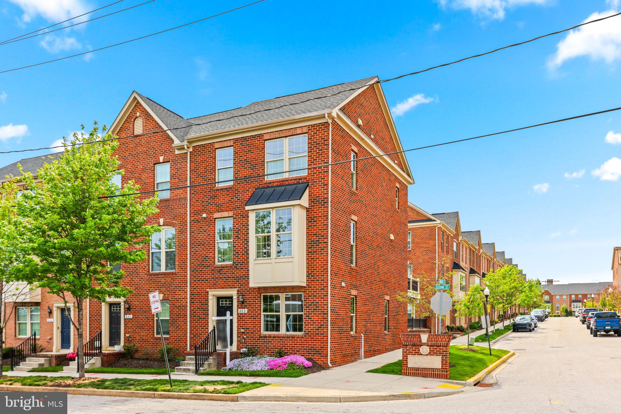Welcome to 840 Oldham—an exceptionally rare end-of-group townhome in the heart of O’Donnell Square, offering the convenience of a two-car garage plus a two-car driveway—a true standout in the community.

Enter to find a spacious entryway, perfect for a home office, gym, or flex space. This level also features a large walk-in closet and a convenient half bath. Ascend the hardwood steps to the main living level, where a gorgeous upgraded kitchen opens seamlessly to a spacious living room featuring a bay window bump-out and additional half bath  creating the ideal layout for both everyday living and entertaining. Just off the kitchen, enjoy access to a large rear deck—perfect for outdoor dining or relaxing.

Upstairs, you’ll find a spacious primary suite complete with a spa-like bathroom and a generous walk-in closet. Two additional generously sized bedrooms, a second upgraded full bath, and a conveniently located laundry area complete this level.

Fresh paint and brand-new carpet make this home completely move-in ready. With its premium end-unit location, rare four-car parking, and stylish updates throughout, this is a unique opportunity you won’t want to miss in O’Donnell Square.