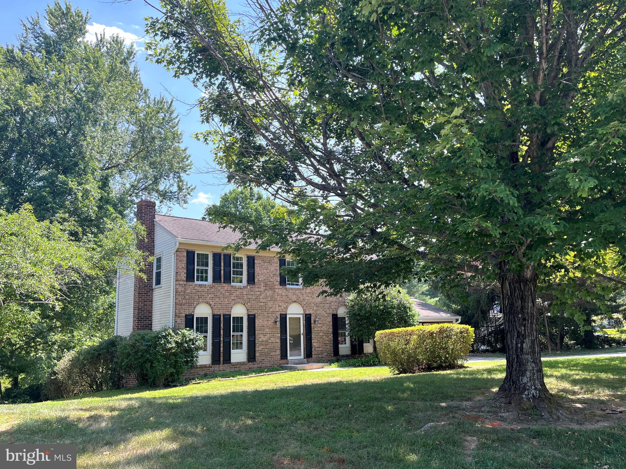 This Brick Front Colonial sits on a BEAUTIFUL .685 acre lot; is freshly painted and  waiting for you to  call it HOME.  The MAIN LEVEL Features a Remodeled Kitchen with Stainless Steel Appliances, Spacious Updated Cabinetry and Counter. Pantry Closet; a Family Room boasting a Brick Fireplace and  a side door that allows easy access to and from the Spacious Covered Carport; Separate Living Room and Dining Room, Powder Room, Brand New Flooring and Brand New Sliding Glass Doors that lead to the GORGEOUS EXPANSIVE DECK.    The UPPER LEVEL offers 4 Bedrooms, Brand New Carpeting, 2 Bathrooms, including one off the primary bedroom (which features a Walk-in-Closet).  The LOWER LEVEL has also had Brand New Flooring installed. The family room shows off a stunning wall of brick surrounding the Fireplace (that has been fitted with a Brand New Wood Burning Stove). This level also features a laundry area, work shop/storage area a bathroom Rough-In and sliding glass doors that leading directly to a patio and the STUNNING Back Yard.  Tour today!