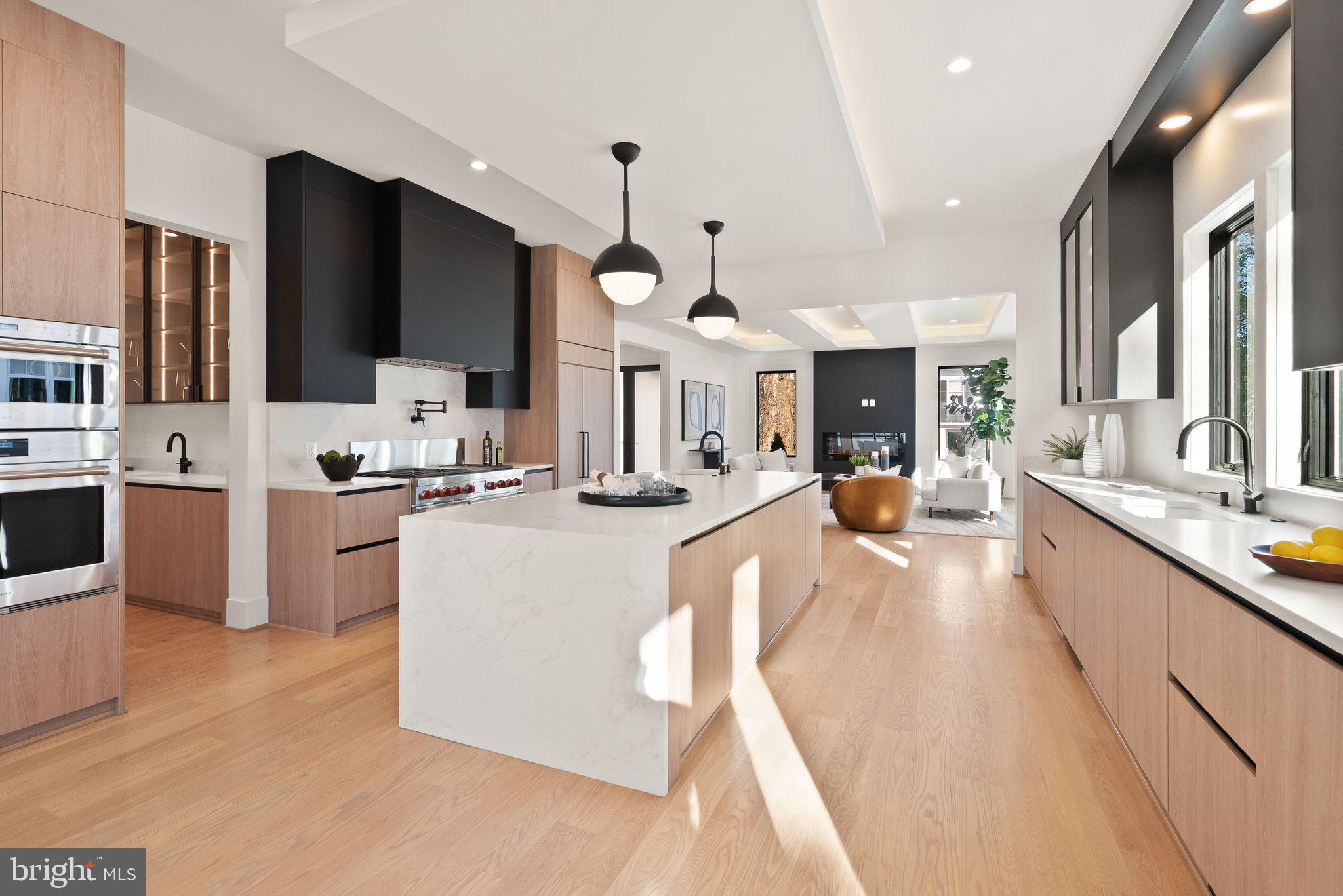 Explore an exceptional contemporary residence in LYON PARK, Arlington—a newly constructed masterpiece featuring an ELEVATOR and a spacious 4-CAR GARAGE. This luxurious home, spanning approximately 6,787 square feet, is perfectly situated on a picturesque 0.27-acre corner lot. With its two grand entrances, the home unfolds across three beautifully finished levels, including a bonus office/bedroom suite above a detached two-car garage. Inside, discover 8 bedrooms, 8 full baths, and 2 half baths, offering expansive and meticulously crafted living spaces. 

An ELEVATOR  ensures effortless movement between all levels, while a state-of-the-art 2-zone HVAC system in the main house, plus a third zone above the garage, provides personalized climate control. The heart of this home is its exquisitely designed kitchen, seamlessly connecting to a welcoming family room with an elegant electric fireplace. This culinary space features an oversized Quartz island, dual sinks, a Miele dishwasher, a professional-grade 48-inch Wolf range with 6 burners and an infrared griddle, a 48-inch Subzero refrigerator, CUSTOM CABINET LIGHTING , and a generous pantry. Adjacent, a butler’s pantry with a sink, beverage cooler, Quartz countertops, and CUSTOM LIGHTING adds to the convenience and ambience. Step outside to a serene screened-in stone porch with a ceiling fan, overlooking the private, beautifully landscaped fenced backyard. 

Entertain effortlessly in the sophisticated dining room or work comfortably from the main level front bedroom/office with its own full bath. The LUXURIOUS PRIMARY SUITE upstairs boasts a spacious bedroom with an electric fireplace, coffee wet bar with a beverage cooler, a LARGE, CUSTOMIZED WALK-IN CLOSET, a private balcony, and a lavish primary bath featuring a large glass-enclosed shower with dual shower heads and body sprays, dual vanities, a soaking tub, and a separate toilet room. Four additional private ensuite's and a well-equipped laundry room complete this level. The walk-up lower level is an entertainer’s paradise, featuring a SIGNATURE QUARTZ BAR  with a beverage cooler, dishwasher, and glass shelving with custom lighting, a large recreation room, a bedroom with a full bath, and a media room. Outside, the professionally manicured grounds are enhanced by a black aluminum fencing in the front, PVC fencing in the back, permeable pavers driveway, an attached 2-car garage with epoxy flooring and an EV charger, and a detached 2-car garage with epoxy flooring and EV charger as well as an additional office/bedroom suite above this garage. This residence truly embodies contemporary elegance and sophistication. A block to Zitkala-Sa Park and near Clarendon's Metro, restaurants, shops, services, and nightlife.  Ring doorbell video cameras at entrances
Don't miss out!!   Location, Location, Locati
