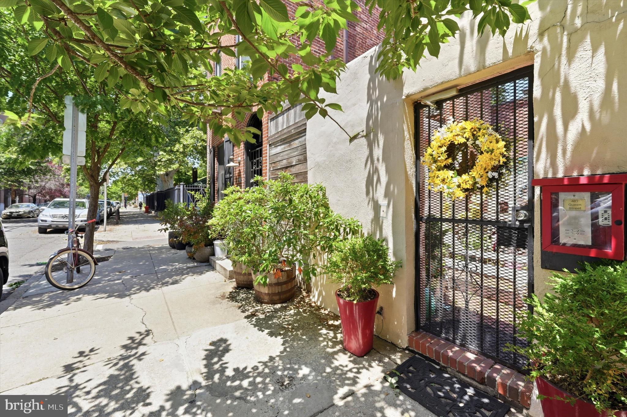 Some homes ask you to choose between the perfect location and the perfect interior. This one refuses to make you decide. Tucked into one of Philadelphia's most storied stretches — Historic Fabric Row in Queen Village — this deluxe bi-level one-bedroom, one-and-a-half-bath condo puts you exactly where you want to be. The bagel shop is across the street. A beloved pizza spot and several award-winning restaurants are just steps away. There's a corner store a block over, three coffee shops within a short walk, and on Sundays, the cherished Headhouse Square farmers market is yours for the strolling. Weccacoe Park sits right behind, more Parks sit a few blocks in every direction, the shops invite lazy weekend browsing with friends, and you will simply never run out of places to eat, gather, or wander. This is the kind of address people spend years trying to land — and once you have it, everything else in your life gets easier. The home lives up to its surroundings from the first step. You enter from Queen Street and stroll through a shared garden courtyard to your own private front door — an arrival moment that sets this residence apart from anything else in the neighborhood. Inside, a private entry hall is built for real city living, with dedicated storage, a bike rack, and a tidy mud-room area to drop your bag and keep the rest of the home pristine. From here, characterful trinity stairs — classic, though steep enough that they won't suit everyone — rise to the main living level, where the upgrades truly begin to shine. The gourmet kitchen wraps three walls in soft-close wood cabinetry with generous upper and lower storage, under-cabinet lighting, and a neutral tile floor that complements a full appliance suite: dishwasher, microwave, electric stove, and French-door refrigerator. Just beyond, the living room is anchored by a wood-burning fireplace and rich hardwood floors, with a built-in office nook and room enough for a comfortable seating area and a true dining space — a genuine rarity at this size, and exactly what you'll want when the night moves from one of those restaurants back to your place. A closet-lined hallway keeps storage and utilities tucked away, while a well-placed half bath welcomes guests without ever disturbing your private quarters. Upstairs is your retreat. A sunlit hall — complete with its own laundry closet — opens to a spacious 15x17 primary bedroom beneath a vaulted ceiling, where two oversized skylights with mechanical shades let in light entirely on your terms. A full wall of built-in closets and two additional hidden storage spaces mean everything has its place and you'll never run short. And then comes the showstopper: a true spa bathroom with radiant heated floors, a walk-in vertical spa/ rain shower with multiple settings and a Japanese-inspired bench, a corner jacuzzi tub with a  n-line hot water heater so bath never gets cold, a brightly lit makeup counter, and a separate vanity area with a glass vessel sink and room to breathe. It's the kind of finish that turns the end of an ordinary day into something restorative. All of this belongs to a distinctive four-building condo community built around the shared garden courtyard, with street-level storefronts that lend the address its authentic Fabric Row character. Pre Inspected and ready to move in-clean as a whistle. The home is fully loaded — on-demand water heater, low condo fee, and thoughtful extras throughout — so the location you need and the amenities you want arrive together, with nothing left on your to-do list. Come see why life is better on Fourth Street!