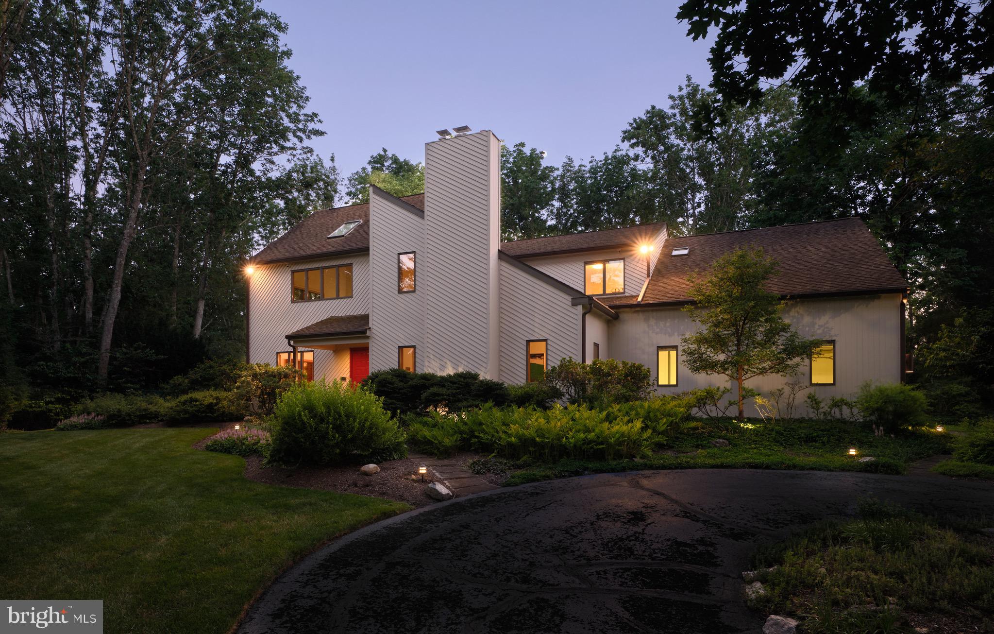 Set on 4.5 private acres, 4029 Devonshire Drive is a beautifully refreshed contemporary retreat surrounded by mature gardens and thoughtfully designed landscaping. Recent interior and exterior painting, refinished hardwood floors, and thoughtful updates give the home a crisp, move-in-ready feel.

Inside, more than 4,100 square feet of finished living space spans the main two levels, plus a fully finished basement. Vaulted and beamed ceilings, skylights, abundant natural light, and a striking architectural staircase add character throughout. The gourmet eat-in kitchen opens to the family room with one of the home’s two fireplaces. A formal dining room, living room, private study, powder room, mudroom, and screened-in porch complete the main level.

Upstairs, the spacious primary retreat features vaulted ceilings, an additional sitting room, a dressing area, two walk-in closets, and an ensuite bath with a soaking tub and separate stall shower. A second bedroom includes its own ensuite bath and a versatile bonus sitting area located just outside the bedroom. An additional bedroom and hall bath complete the upper level.

The finished lower level features heated floors and expands the home’s flexibility with a fourth bedroom, full bath, additional living space, sauna, wine storage, dedicated workshop, and abundant storage.

Outside, lush gardens and mature landscaping create a peaceful sense of privacy throughout the property. The screened-in porch provides an inviting setting for morning coffee, outdoor dining, or quiet summer evenings. A circular driveway, ample parking, and an oversized three-car garage with direct staircase access to the basement complete the property.

Offering exceptional acreage, privacy, refreshed interiors, and access to the highly regarded Central Bucks School District, 4029 Devonshire Drive presents a rare combination of space, setting, and distinctive contemporary style.